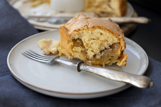 a piece of apple sponge cake on a plate with vintage fork