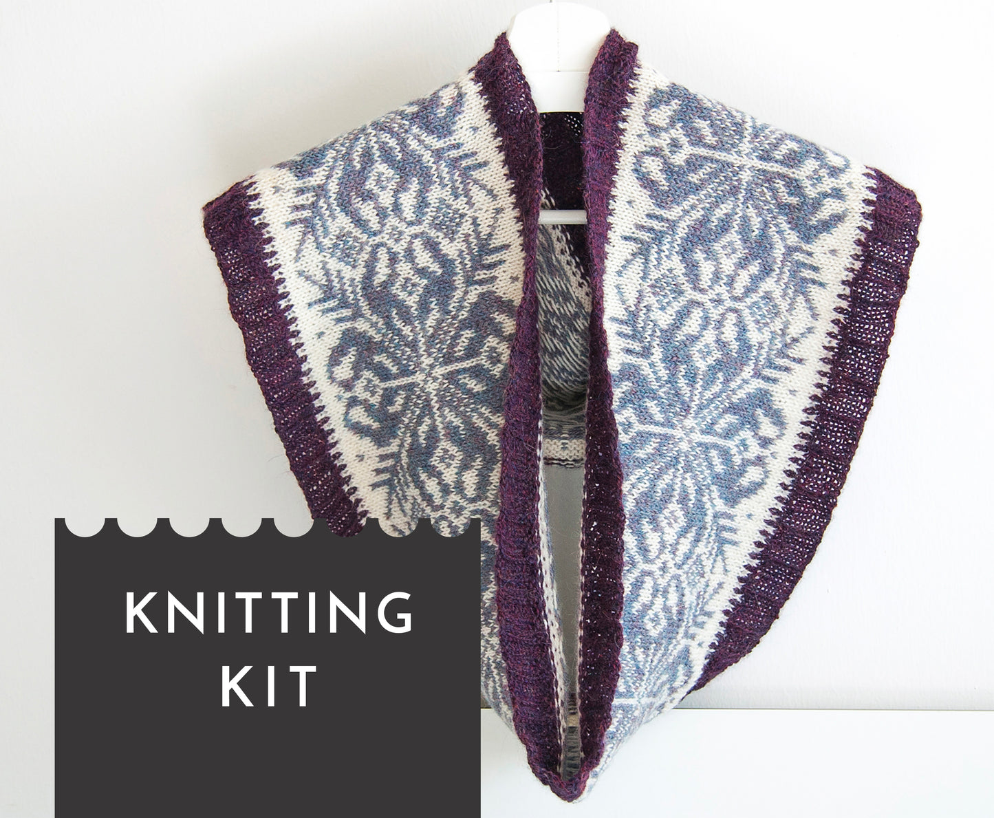 hand-knitted Fair Isle cowl in Snowflake pattern made from purple and white alpaca wool yarn
