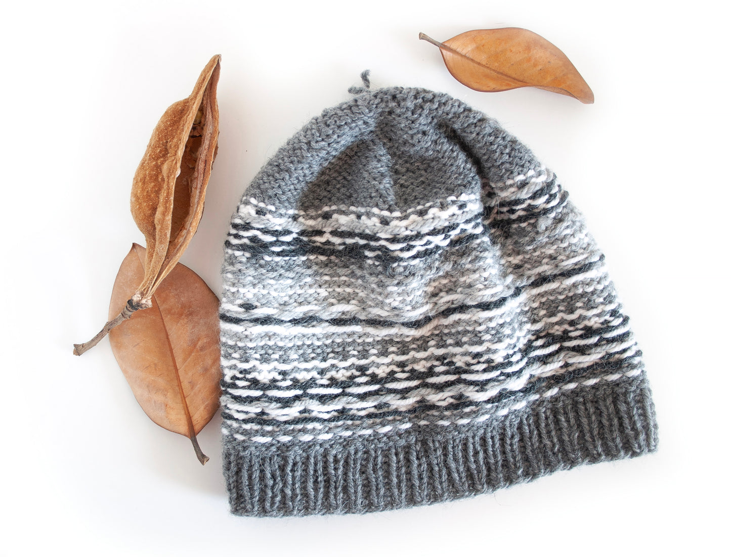 Gray and white hand-knitted Fair Isle beanie hat turned inside out