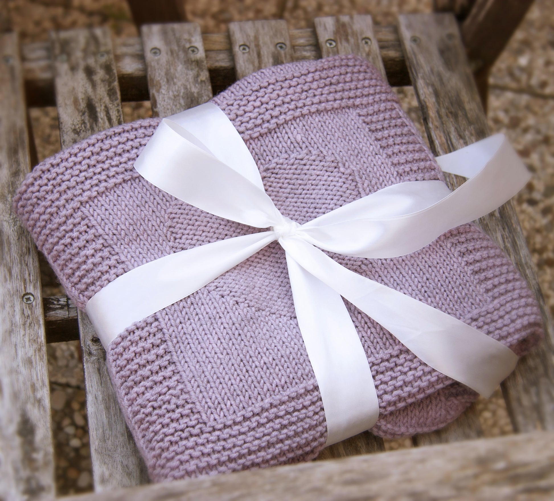 purple merino wool hand-knitted baby blanket in Hearts and Bunnies knitting pattern