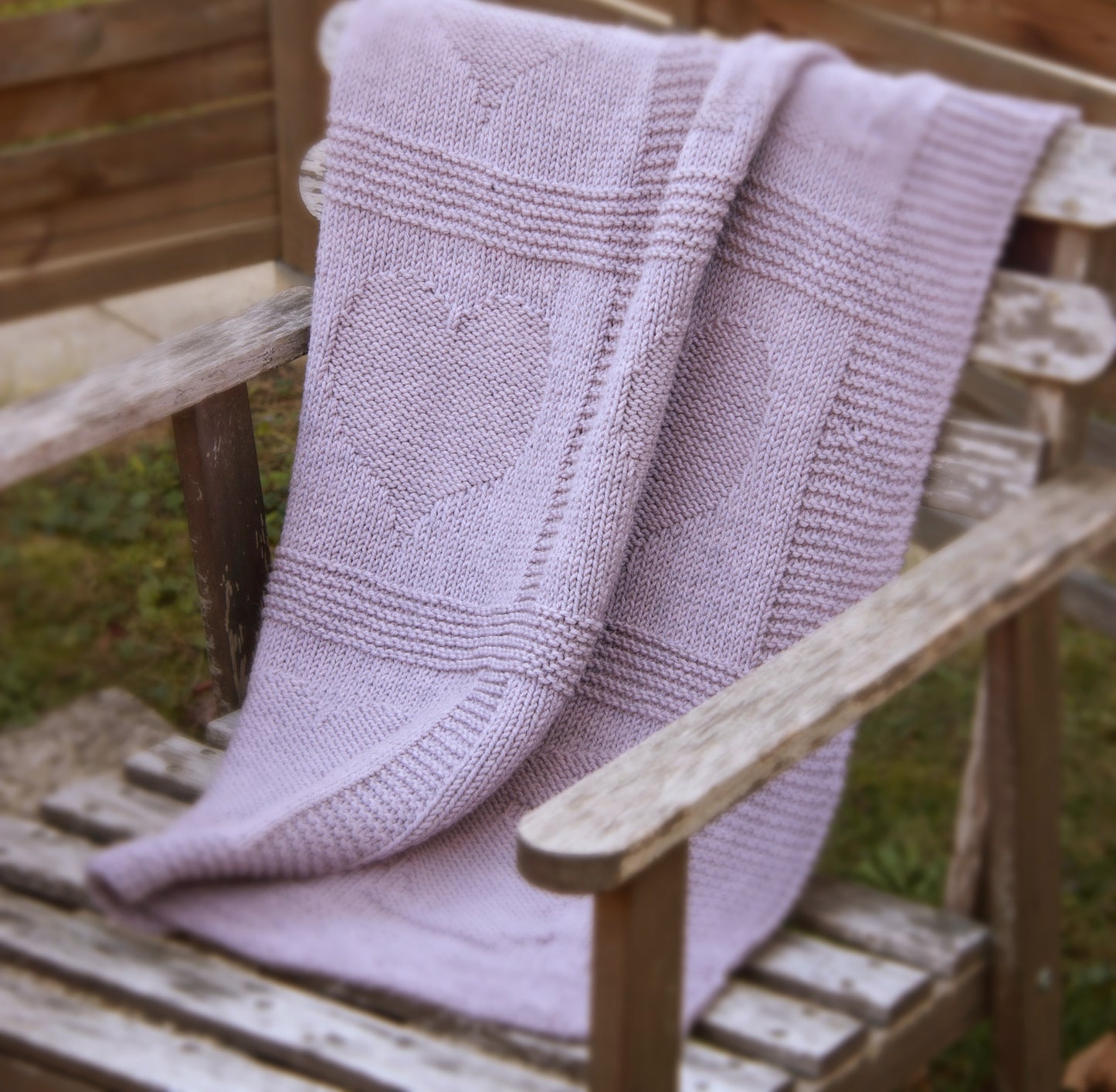 purple merino wool hand-knitted baby blanket in Hearts and Bunnies knitting pattern