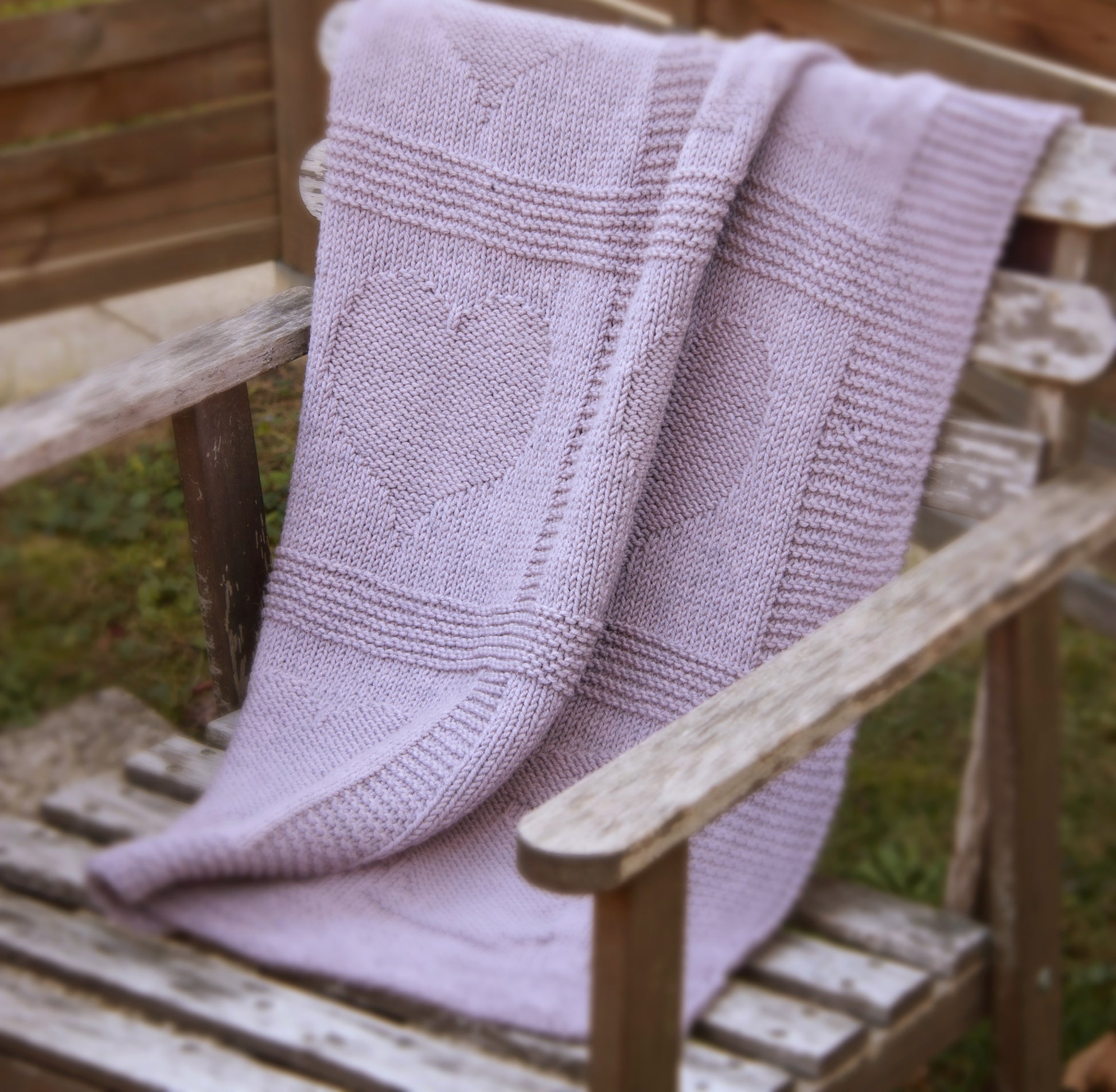 purple merino wool hand-knitted baby blanket in Hearts and Bunnies knitting pattern