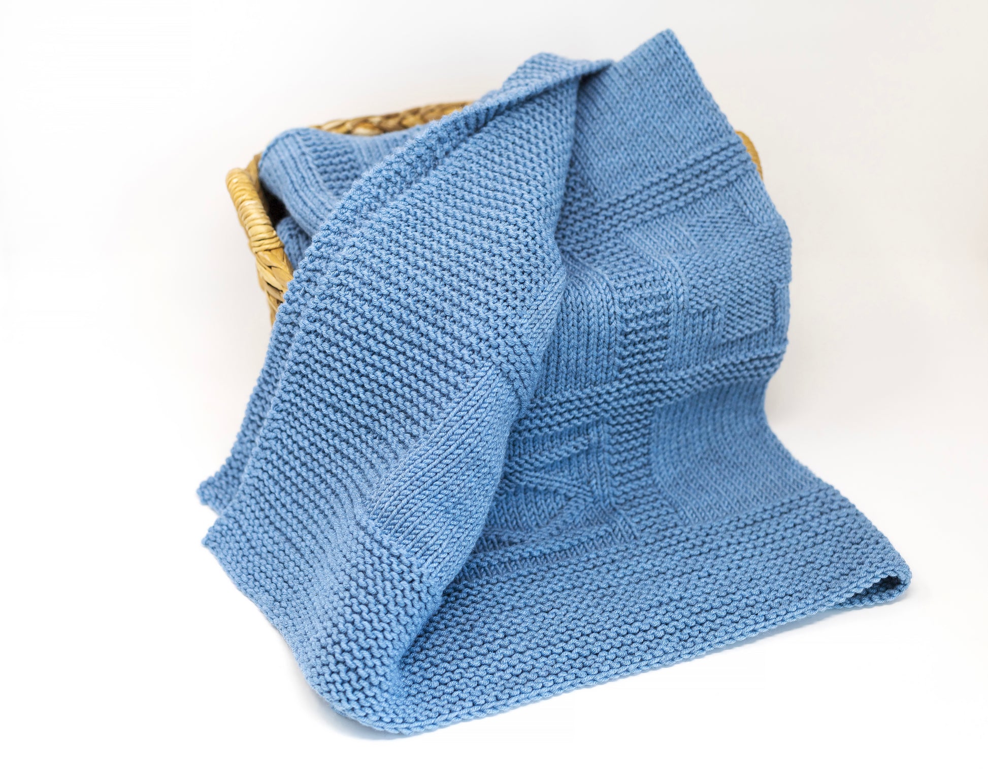 blue merino wool hand-knitted baby blanket in geometric knitting pattern