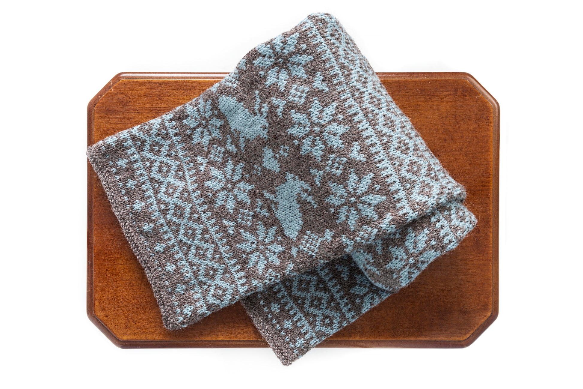 Brown and grey blue wool hand-knitted long Fair Isle scarf in Bunny Rabbit pattern folded on a table