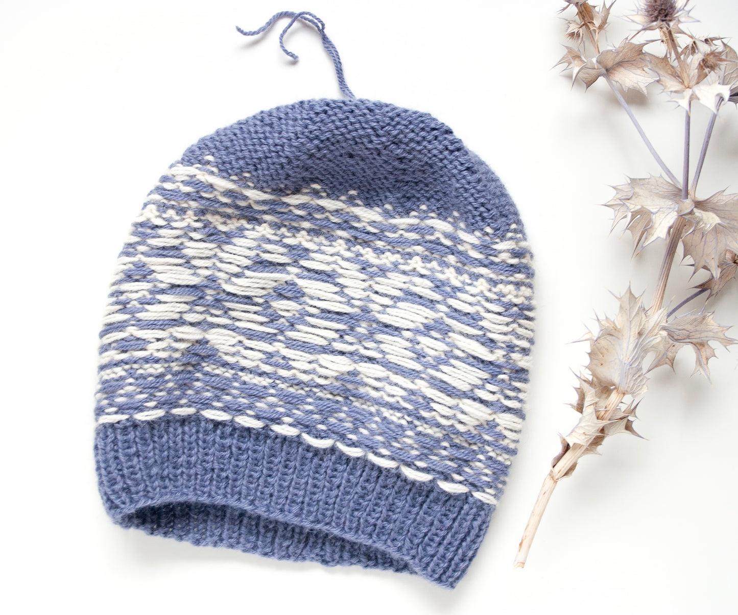 blue and white alpaca wool hand-knitted Fair Isle beanie hat in snowflake knitting pattern, wrong side