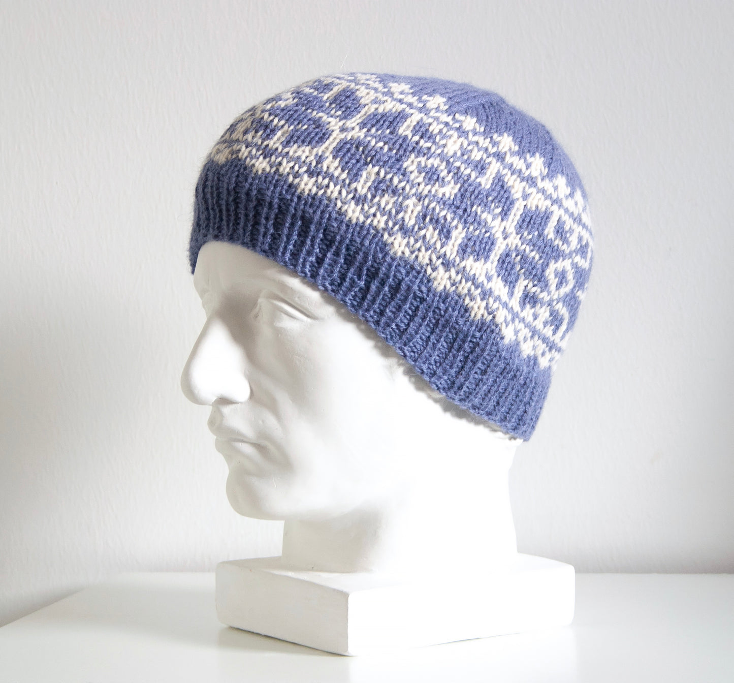 blue and white alpaca wool hand-knitted Fair Isle beanie hat in snowflake knitting pattern