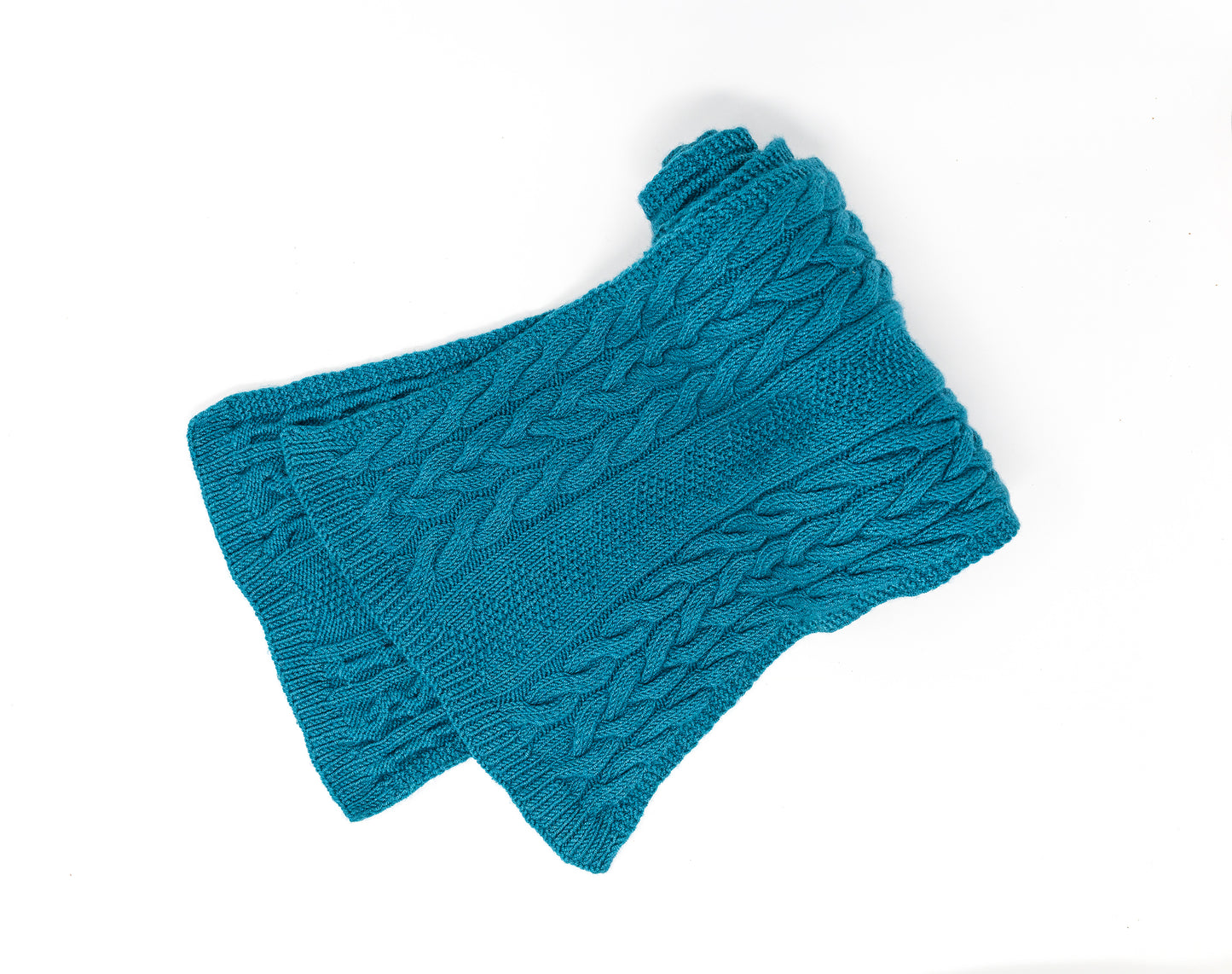 Cable-knit scarf in teal merino wool laid flat on a white background