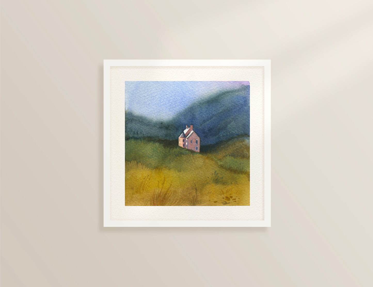 Framed watercolor landscape featuring Culzie Lodge Pink House on Loch Glass in Scottish Highlands nestled in a grassy field with blue mountains in the background.