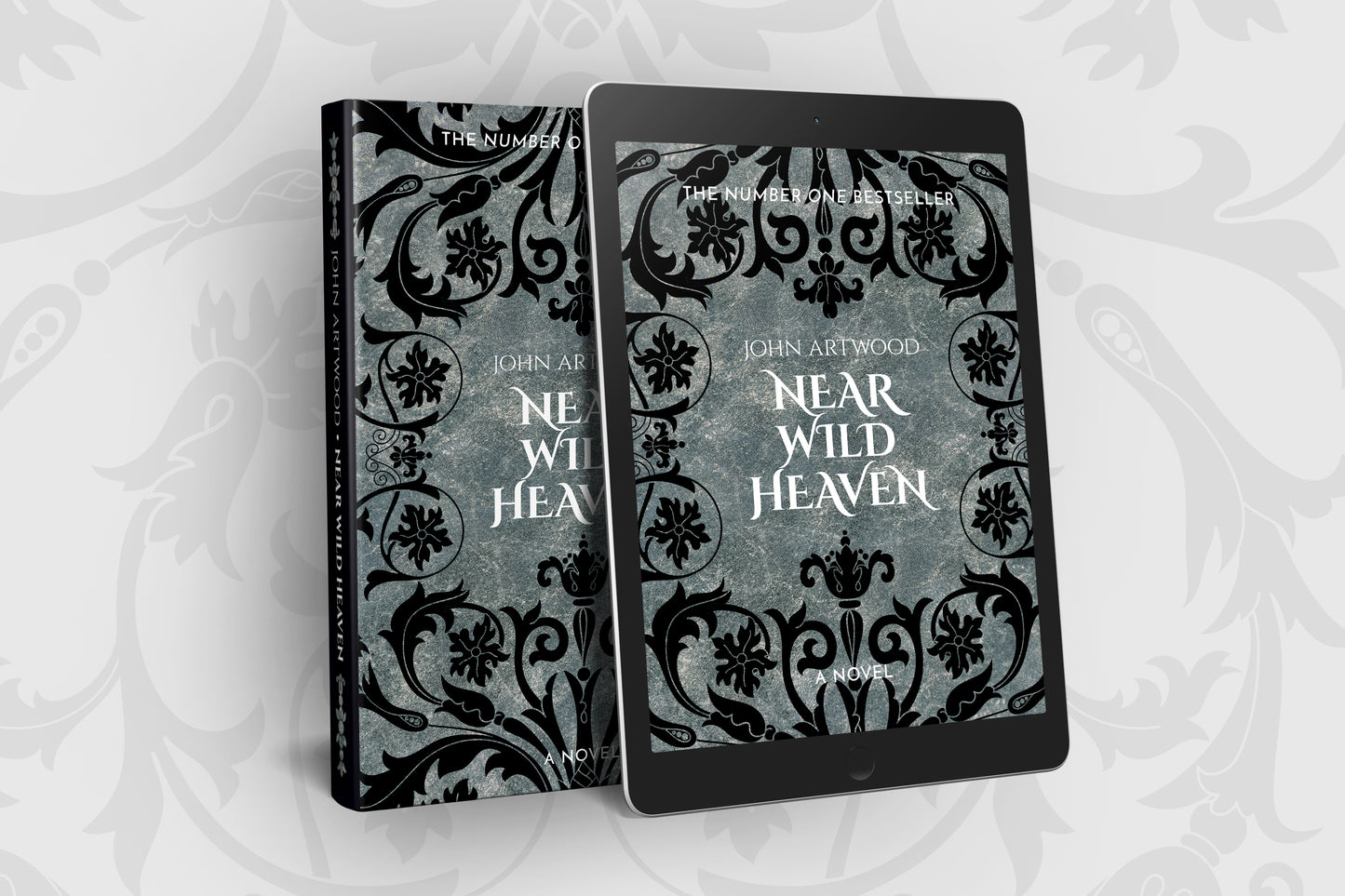 Paperback and tablet with the same book cover with black baroque ornament on a silver background
