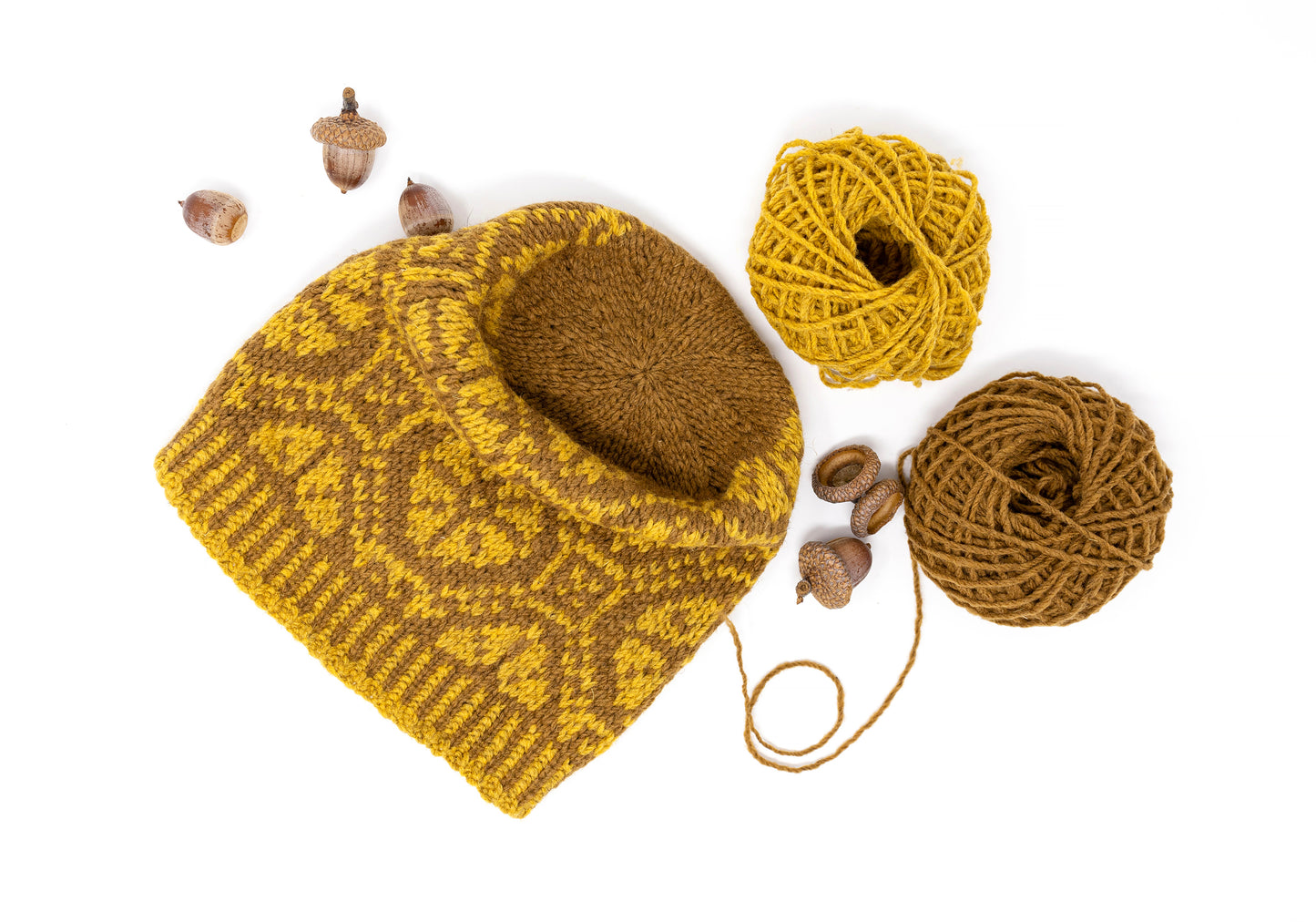 Close-up of Ratas carriage wheel colorwork in mustard and brown
