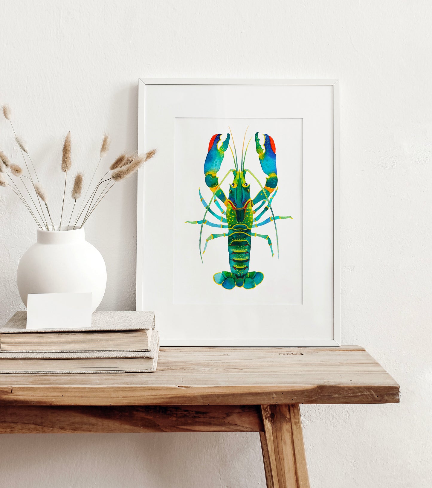 small framed Red Claw Crayfish watercolor art print, displayed on a wooden table