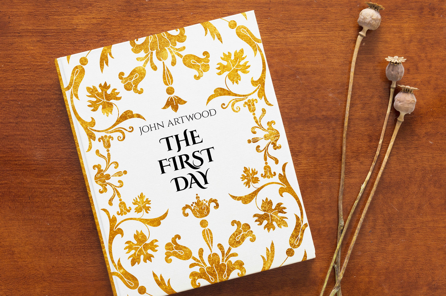 Book in gold and white ornament design on a wooden table