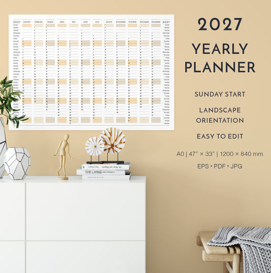 2027 yearly planner on a beige wall with decorative items below