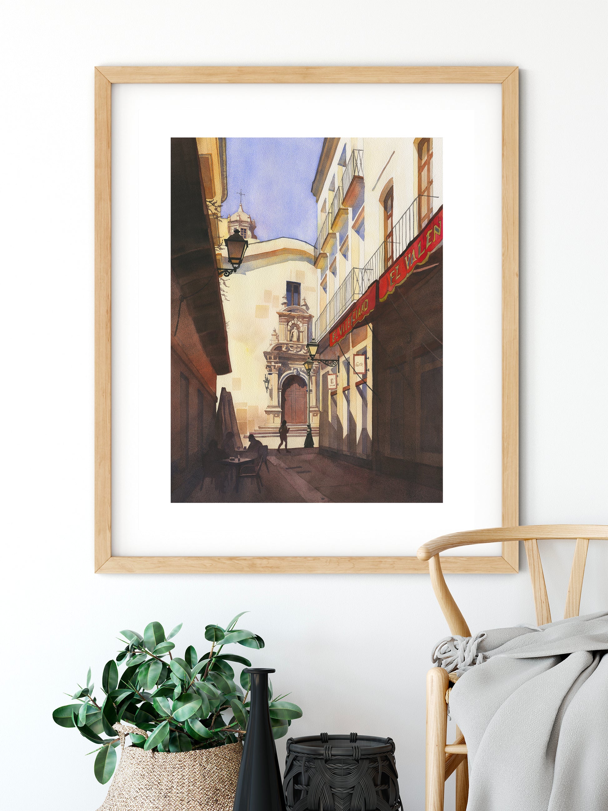 framed watercolor artwork of a street in Almeria Old town, Spain, on a white wall