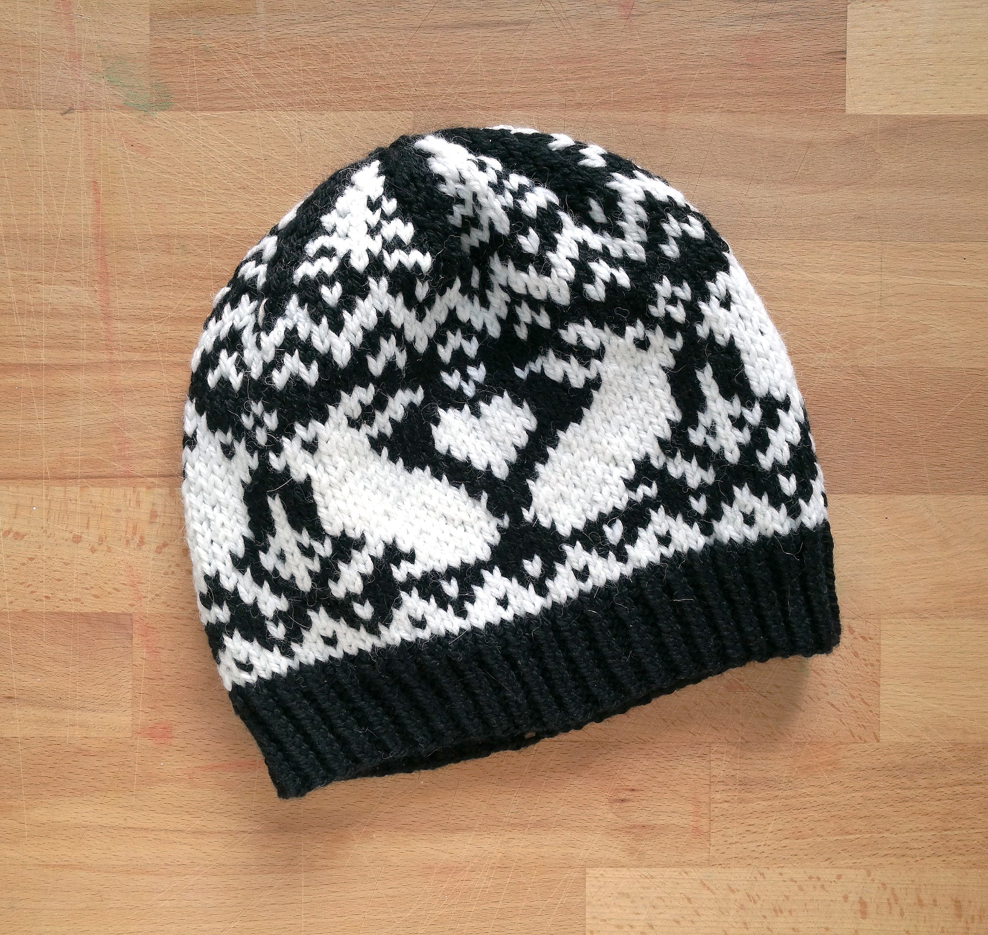 Black and white hand-knitted Fair Isle beanie hat with a bunny motif
