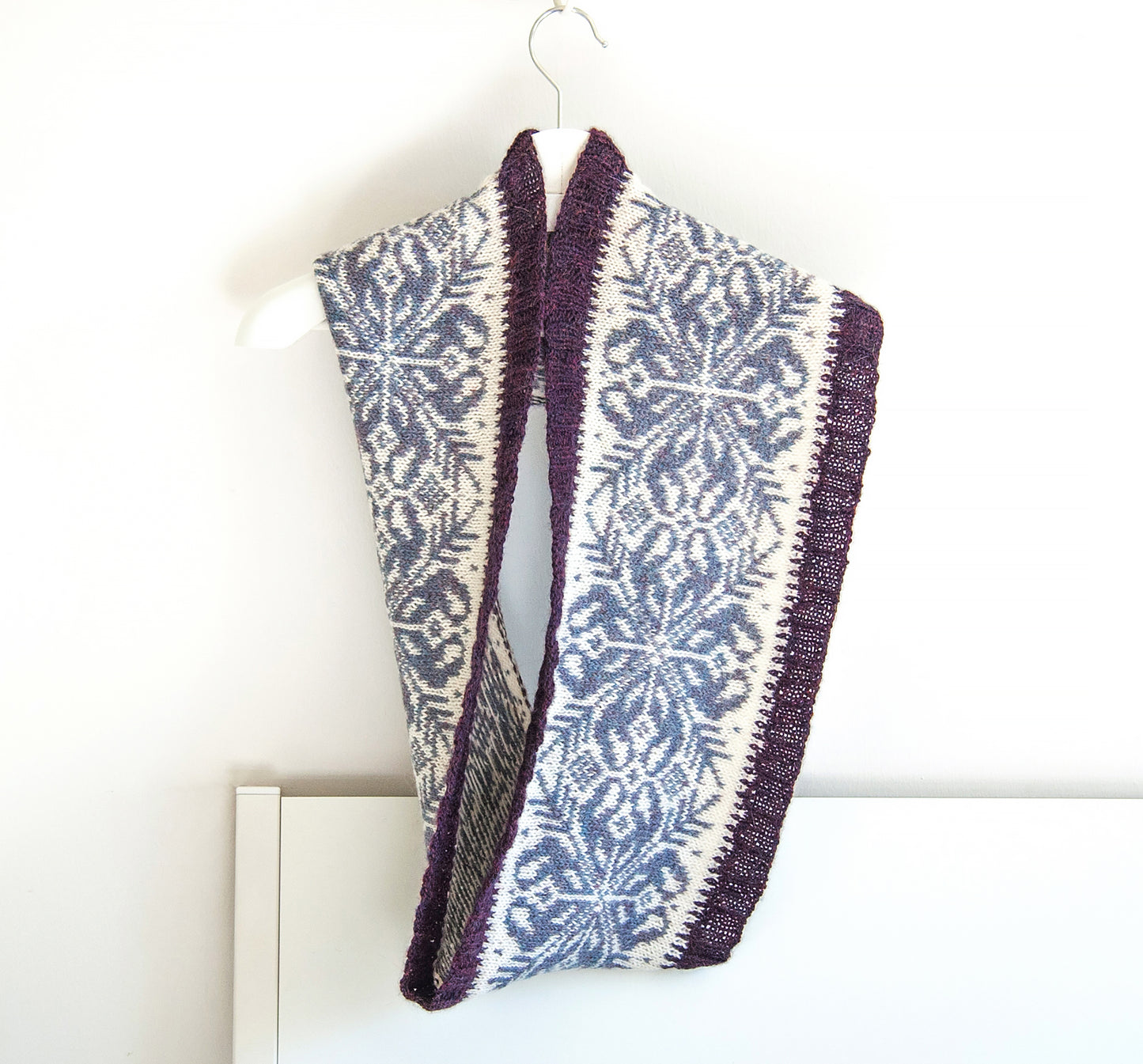 hand-knitted Fair Isle cowl  in Snowflake pattern made from purple and white alpaca wool yarn