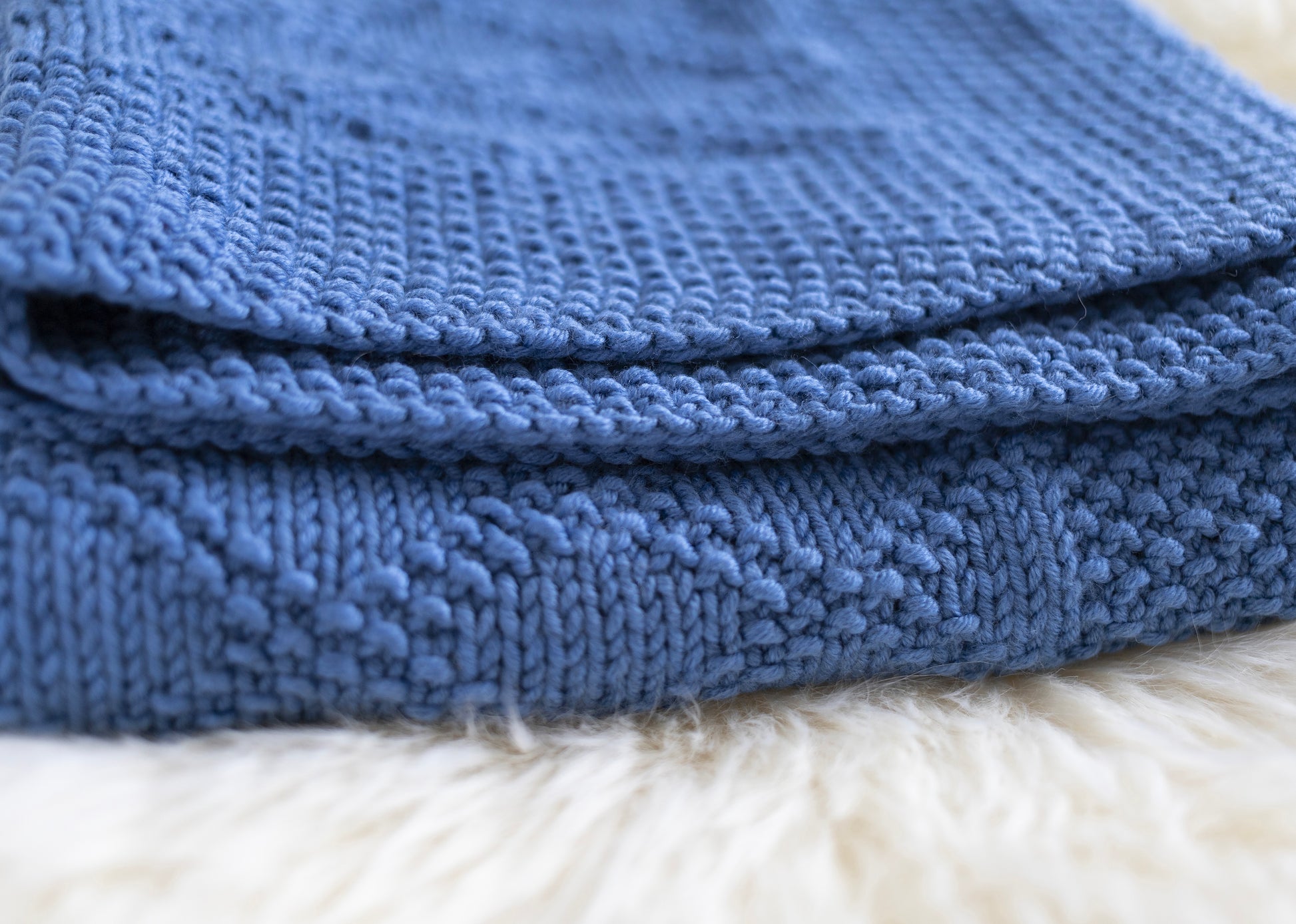 Close up for Blue merino wool hand-knitted blanket in Charles Brocade pattern