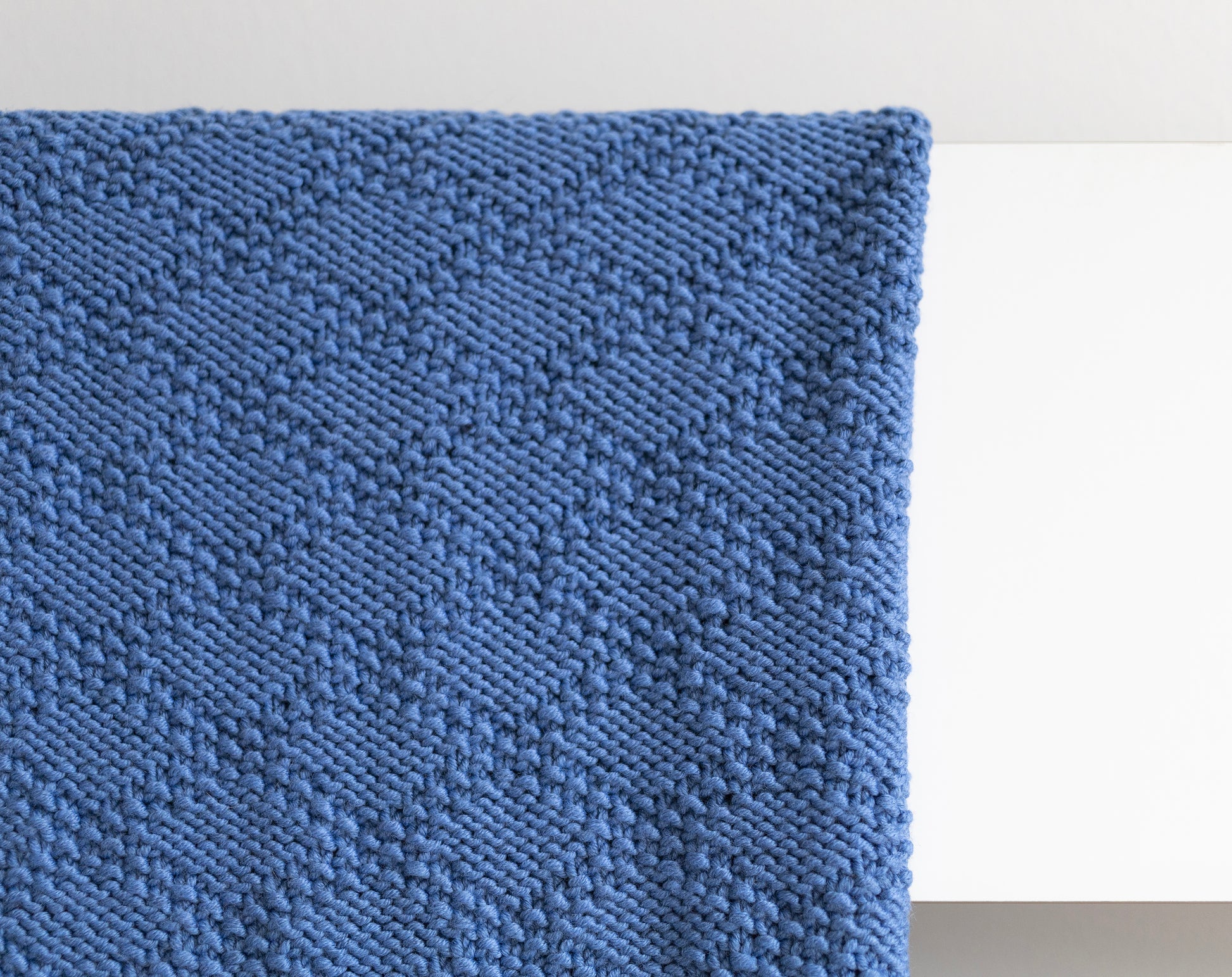 Blue merino wool hand-knitted blanket in Charles Brocade pattern wrong side