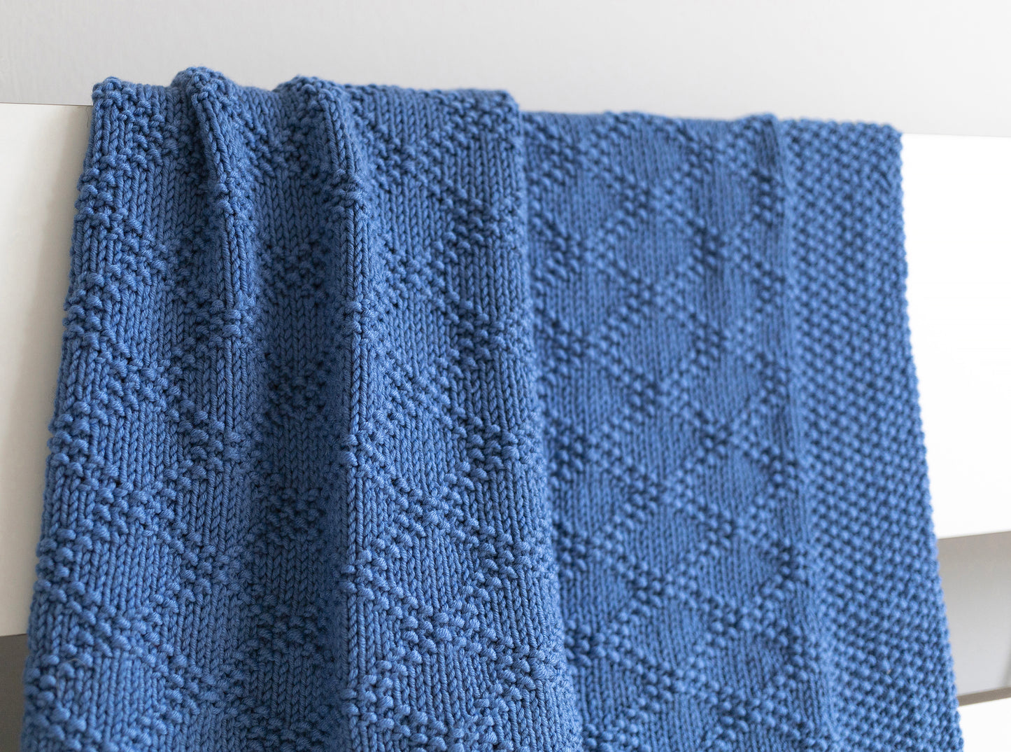 Details of Blue merino wool hand-knitted blanket in Charles Brocade pattern