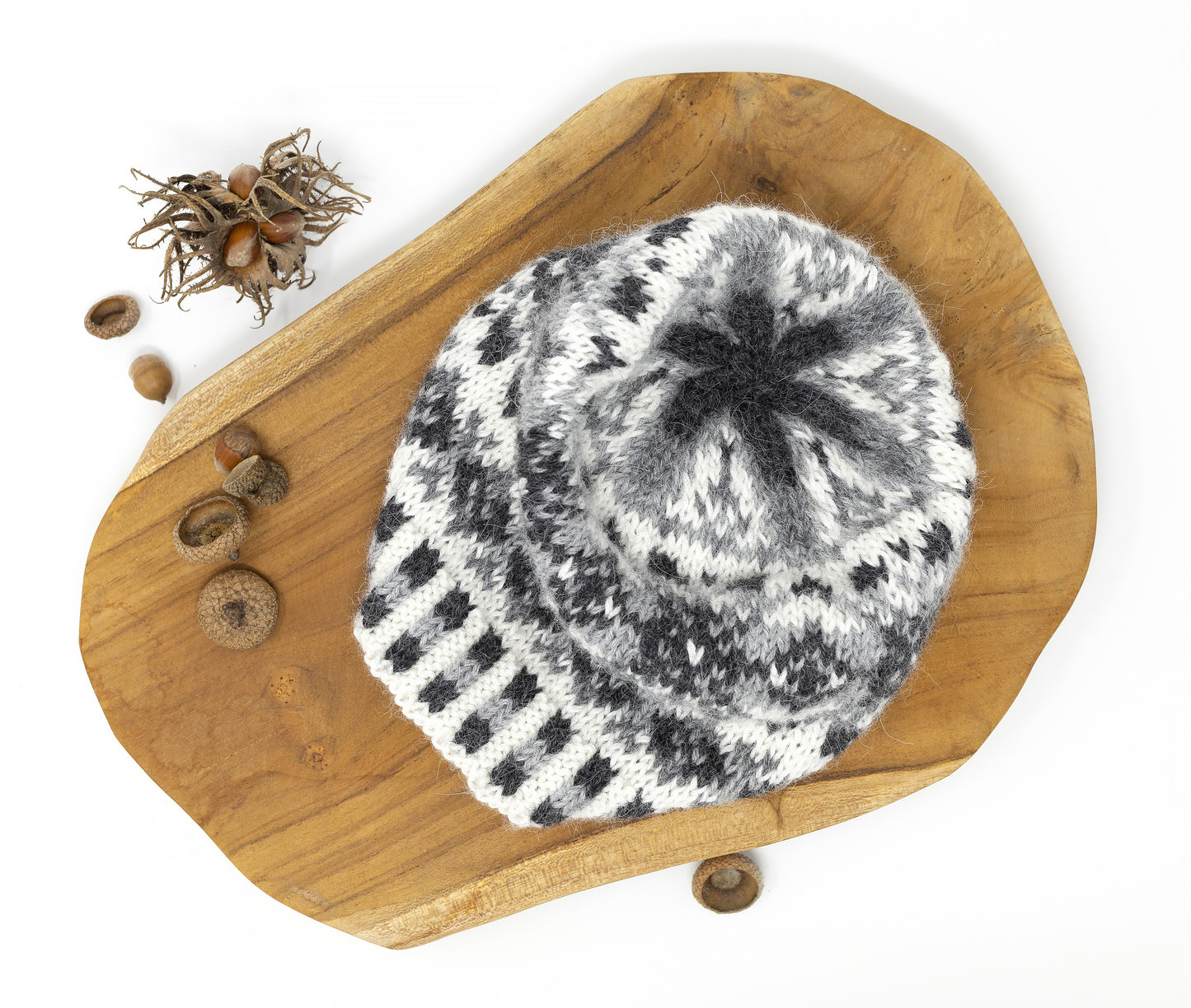 A crown of a grey, white and black alpaca wool hand-knitted Fair Isle hat