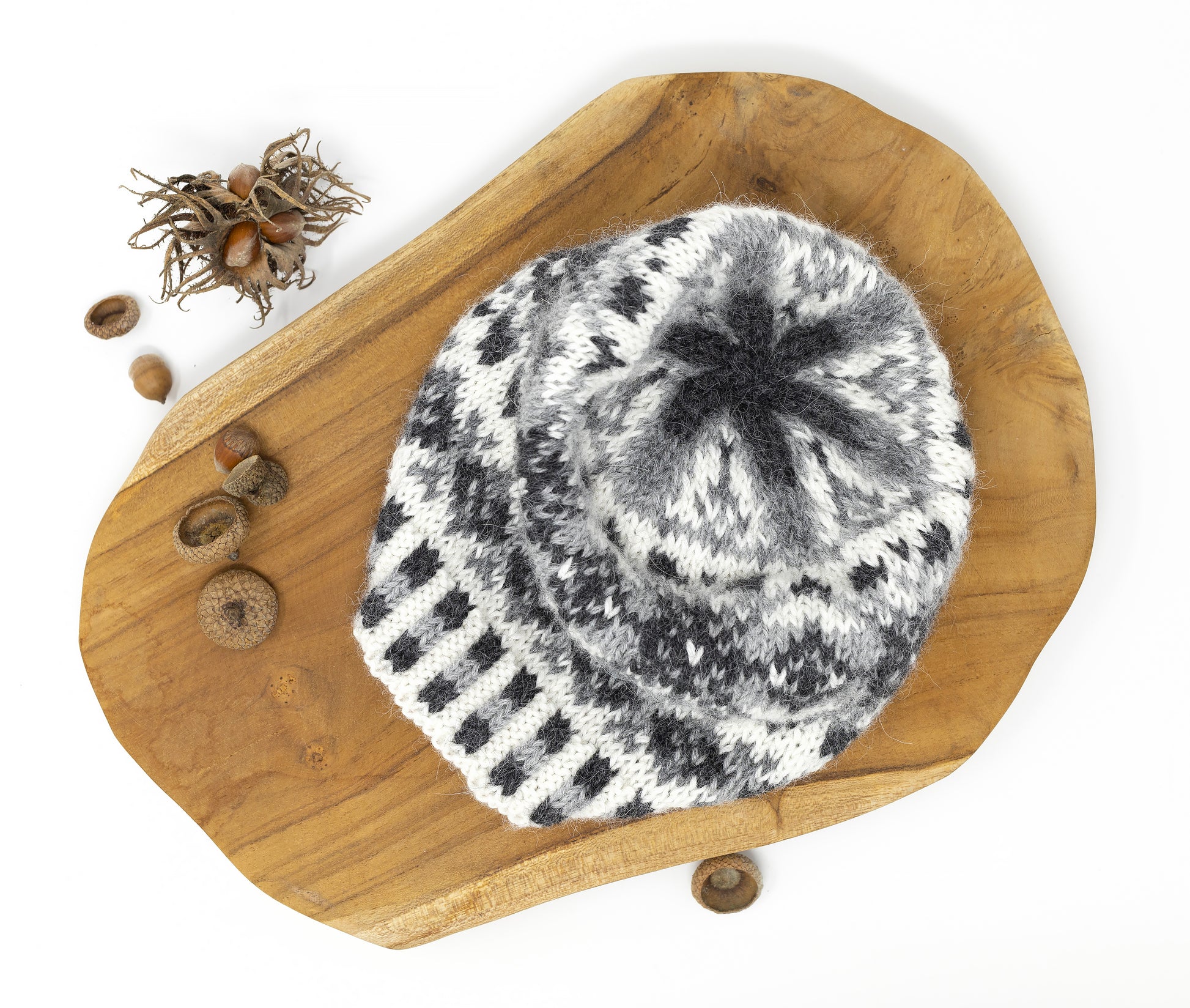 A crown of a grey, white and black alpaca wool hand-knitted Fair Isle hat