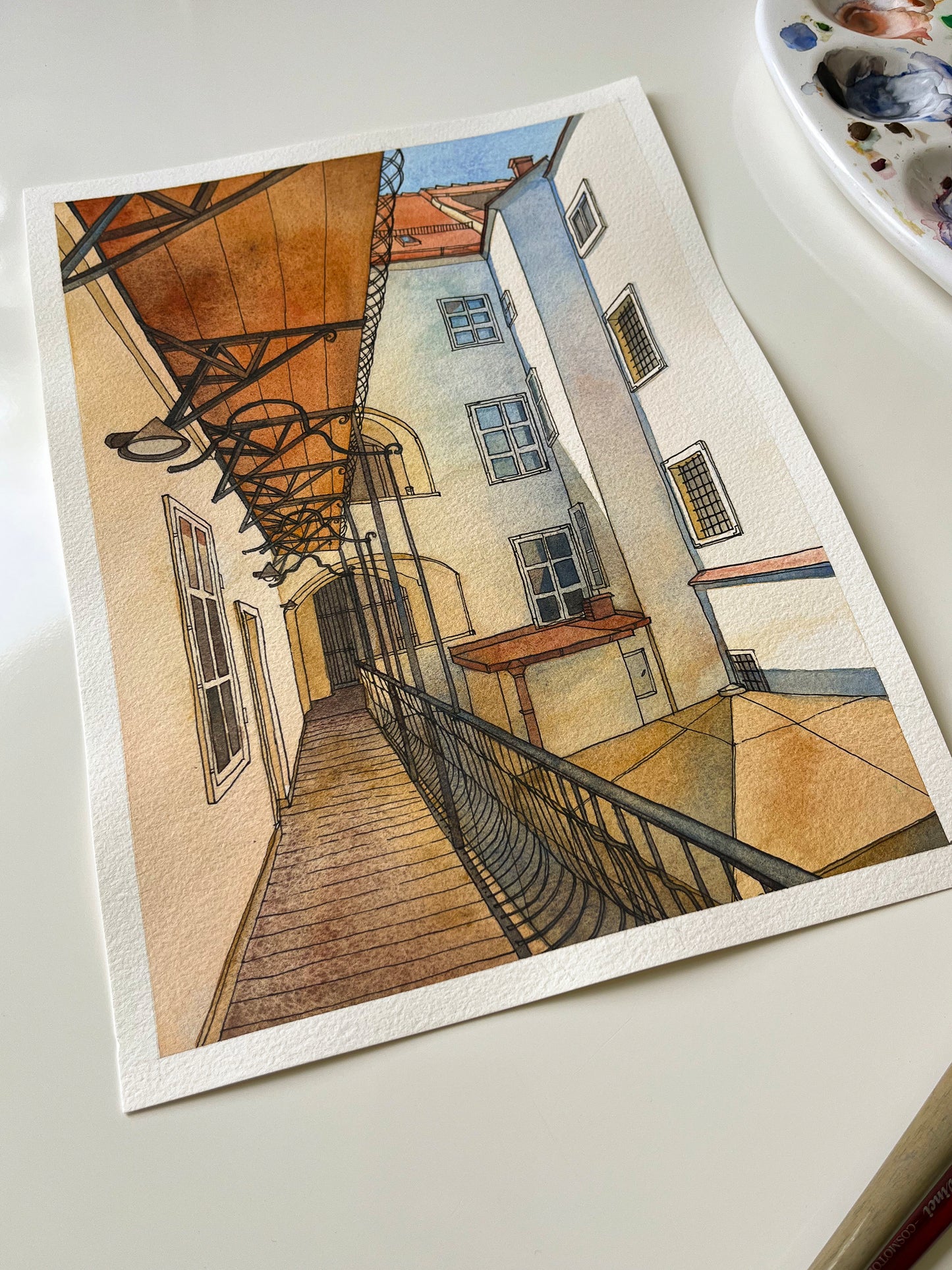original watercolor and ink artwork of a historic courtyard in Graz on a white table