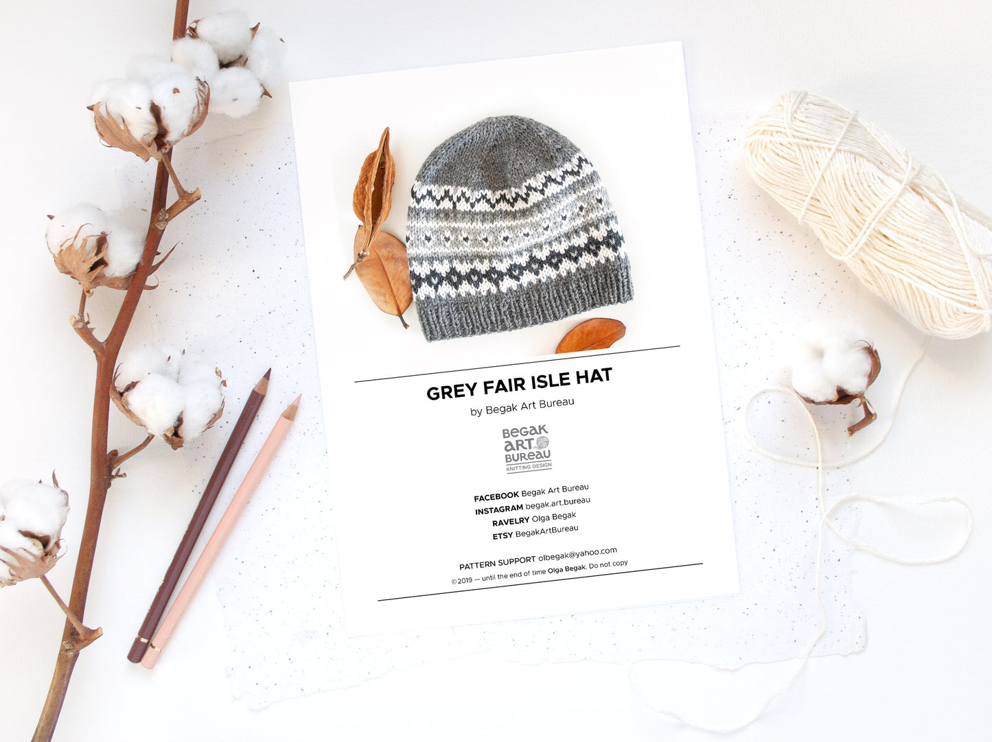 Gray Fair Isle beanie hat knitting pattern booklet accompanied with pencils, yar ball and dryed cotton plant