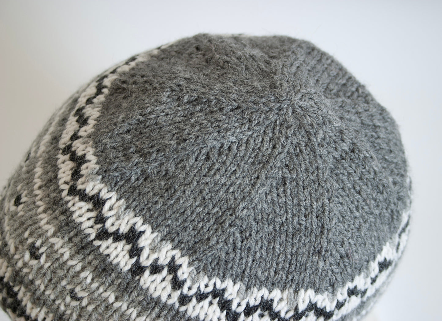 close up for grey, white and black hand-knitted Fair isle beanie hat 