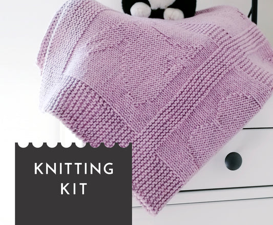 Purple superwash merino wool yarn hand-knitted baby blanket in Hearts & Bunnies knitting pattern