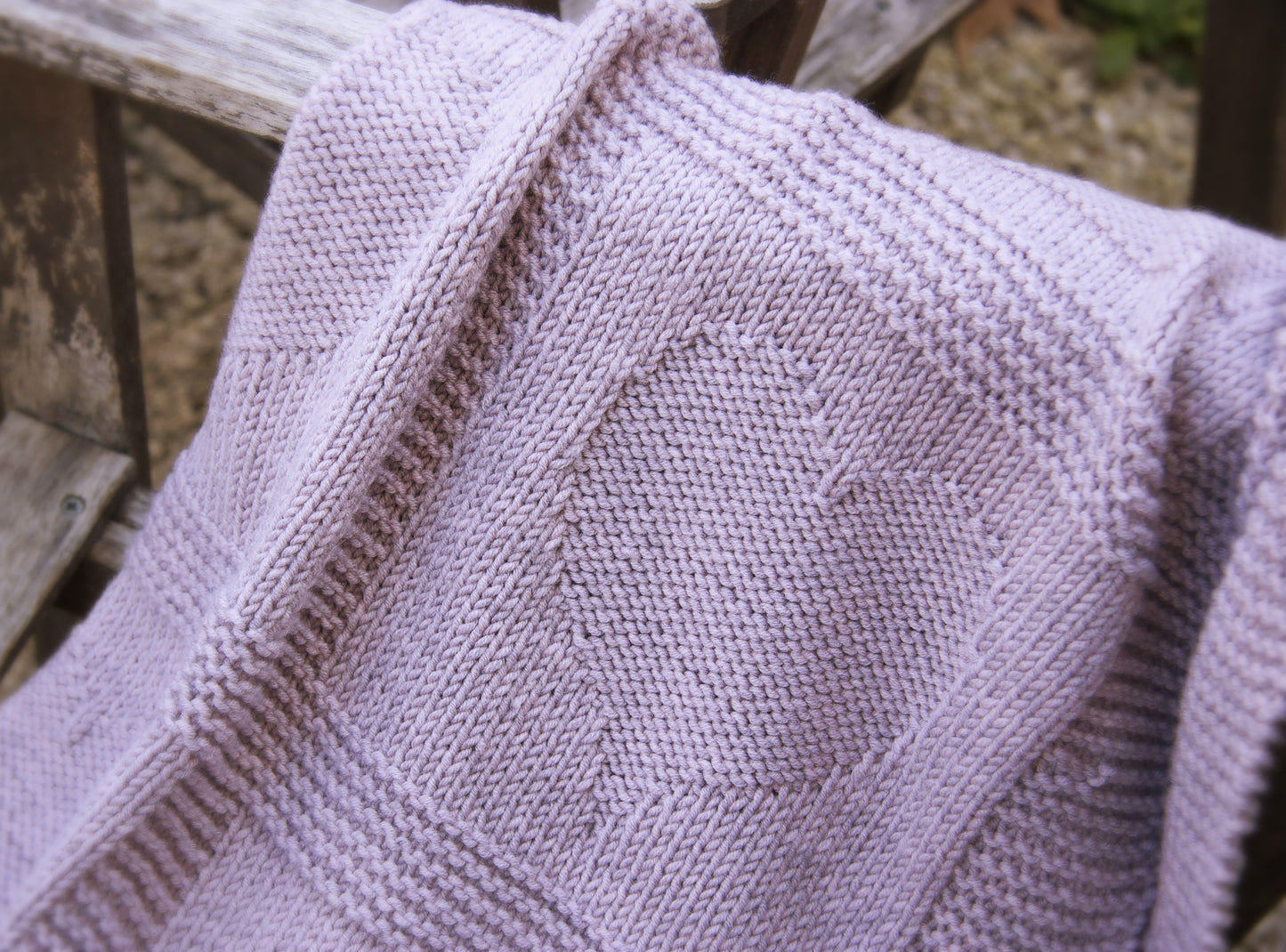 close up for purple merino wool hand-knitted baby blanket in Hearts and Bunnies knitting pattern