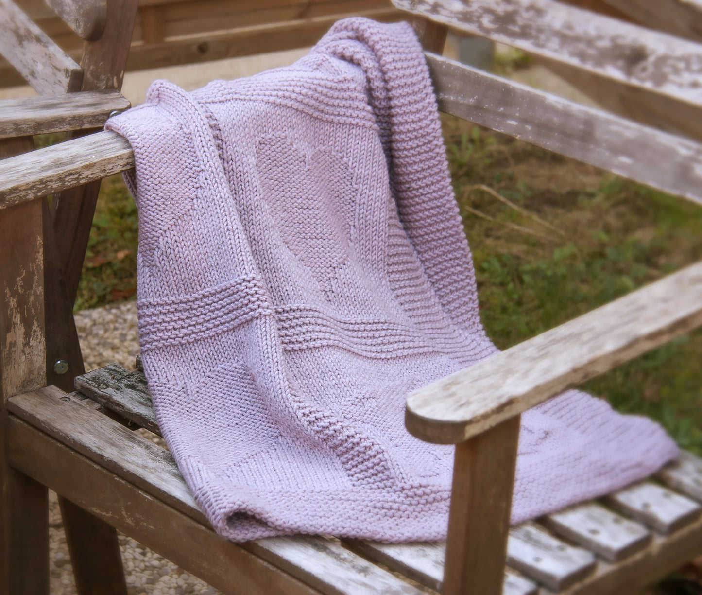 purple merino wool hand-knitted baby blanket in Hearts and Bunnies knitting pattern