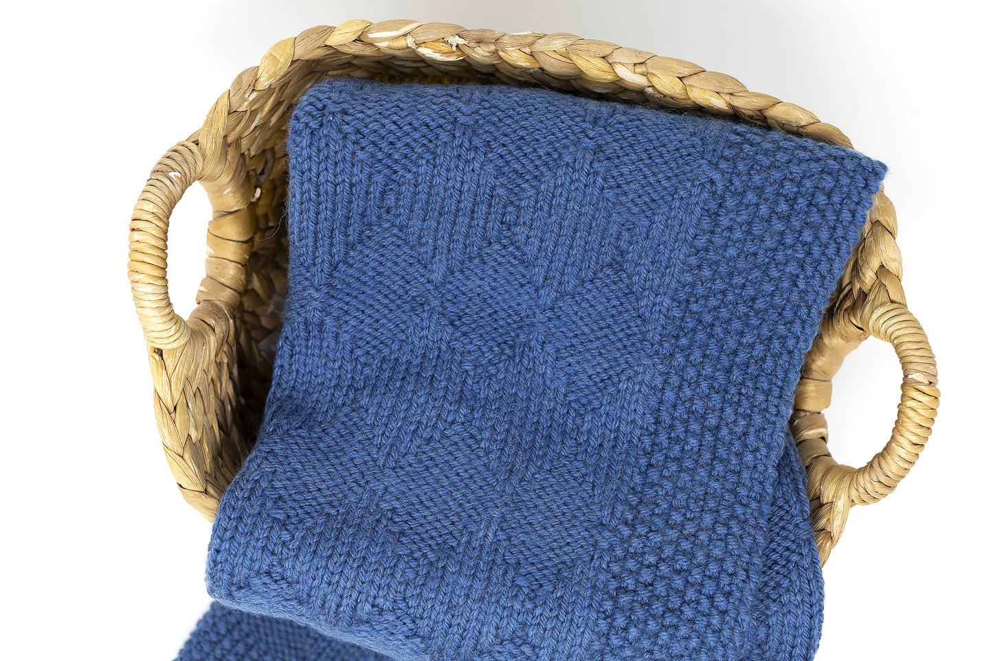 Blue superwash wool hand-knitted baby blanket in Harlequin pattern