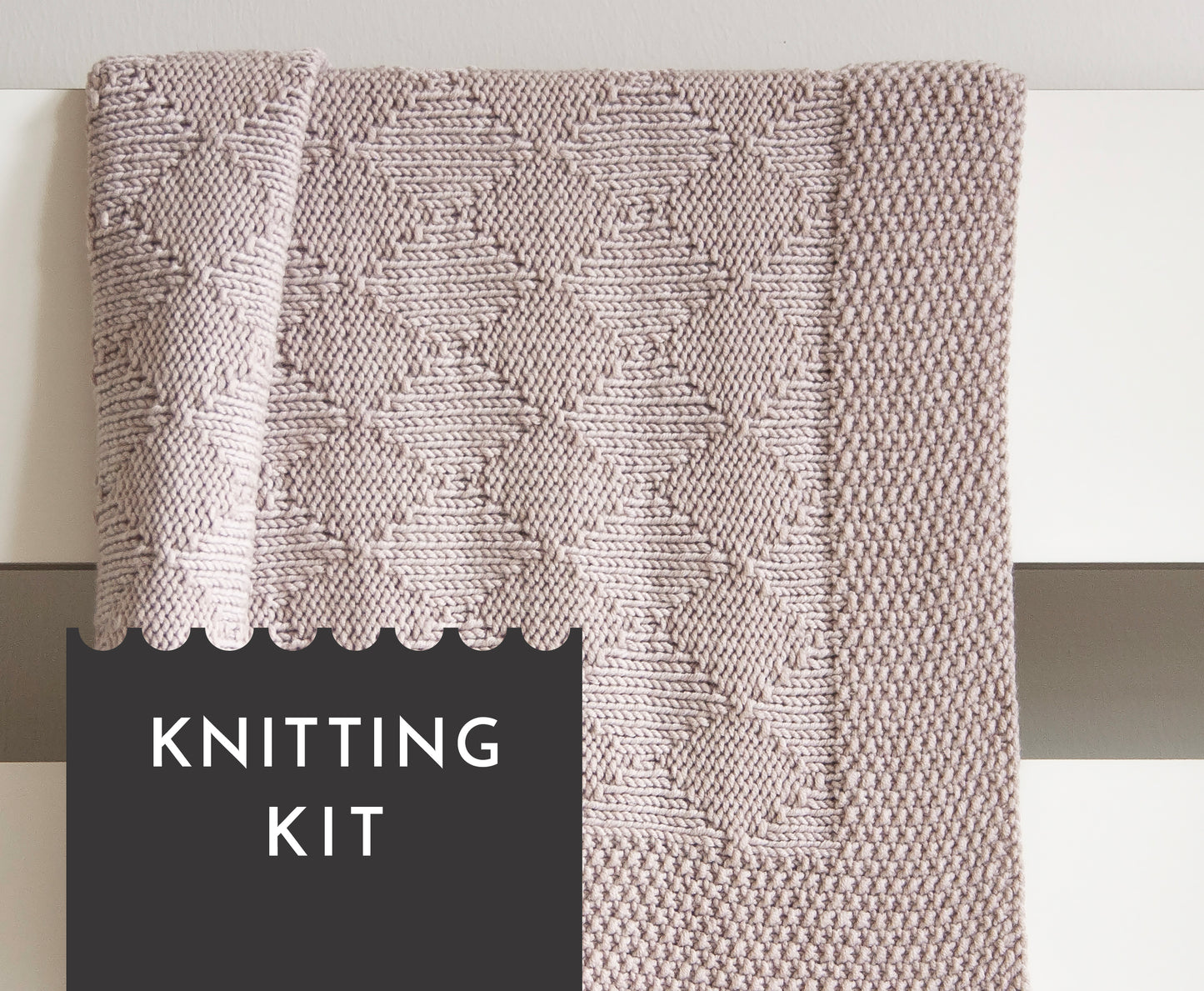 Beige superwash merino wool DK yarn hand-knitted baby blanket in Harlequin knitting pattern