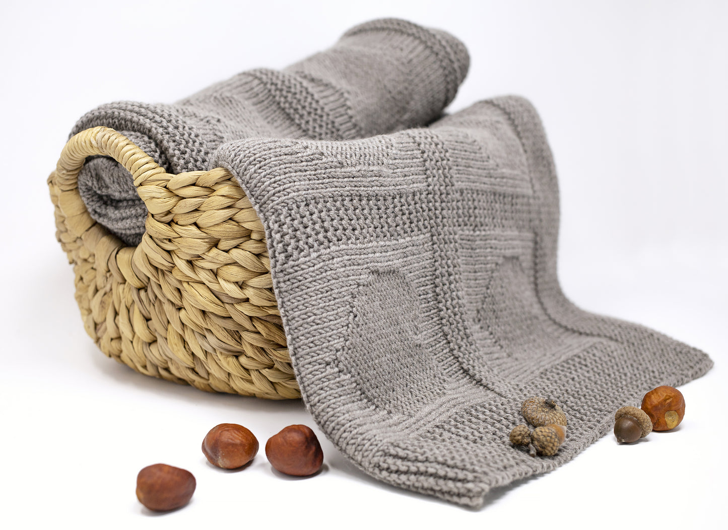 beige brown merino wool hand-knitted baby blanket in Hearts knitting pattern in a basket