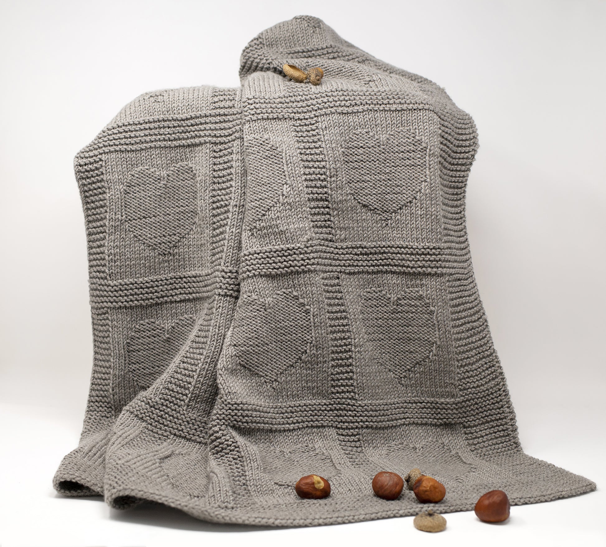 beige superwash merino wool yarn hand-knitted baby blanket in Hearts knitting pattern