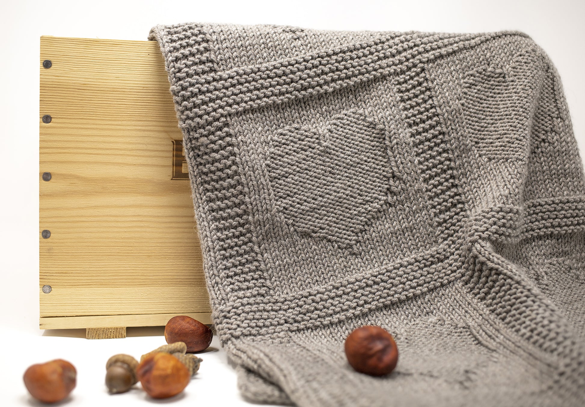 Close-up of heart textured blanket created with knit and purl stitches