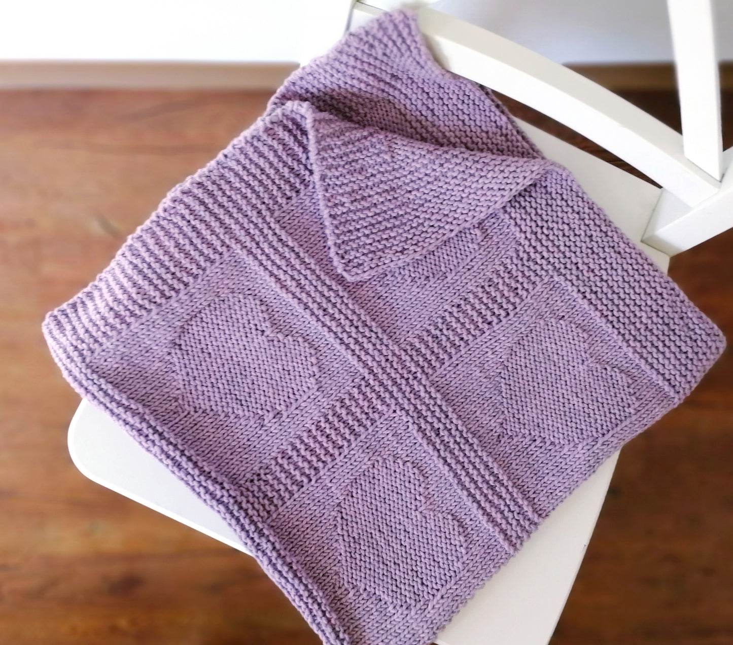 purple merino wool hand-knitted baby blanket in Hearts knitting pattern