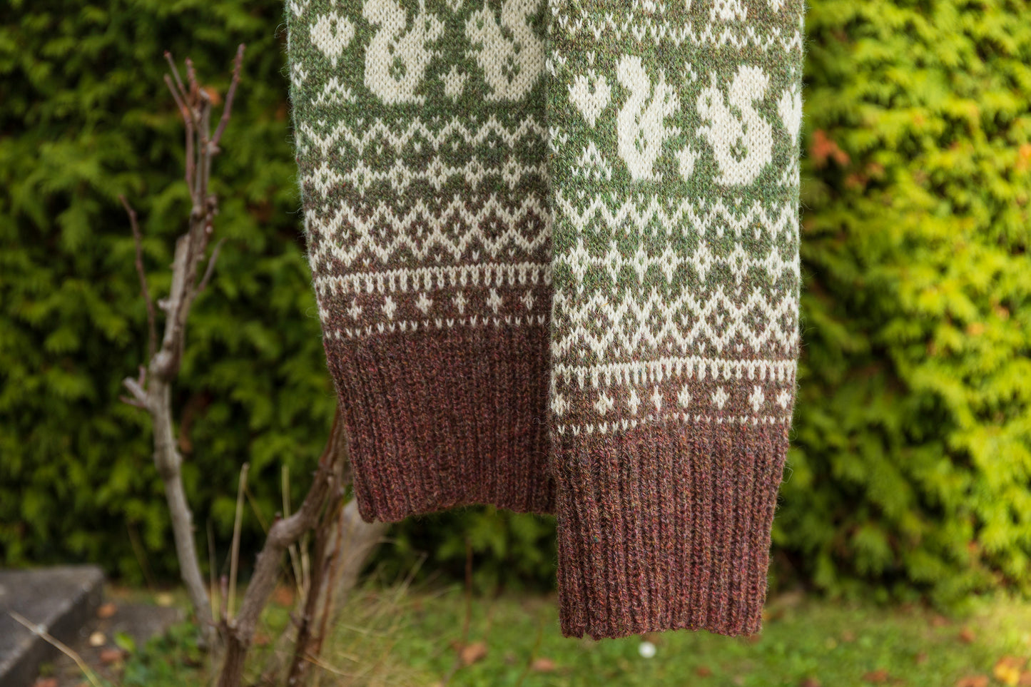 Lahemaa Squirrels scarf hanging against a natural background