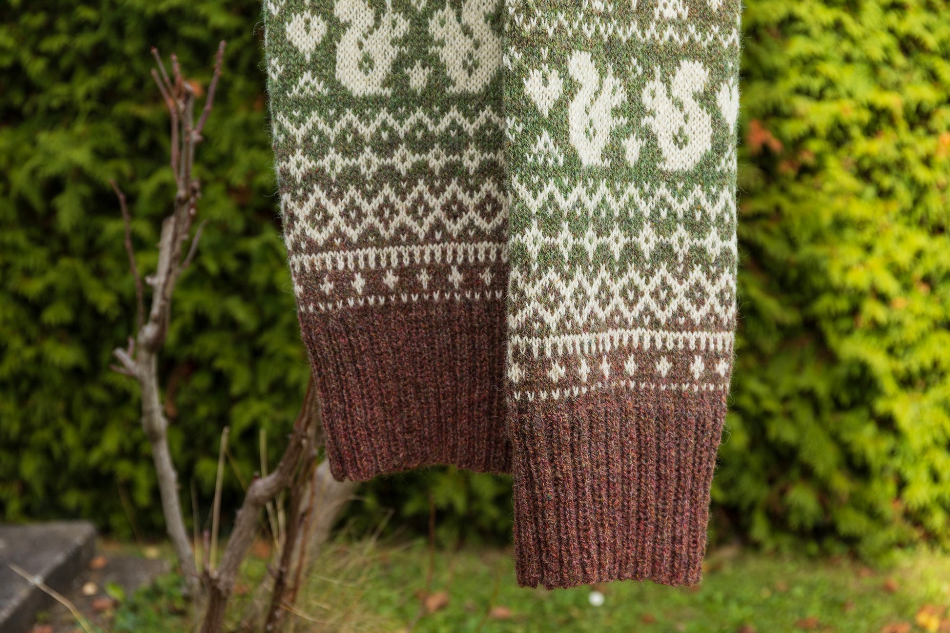 Lahemaa Squirrels scarf hanging against a natural background