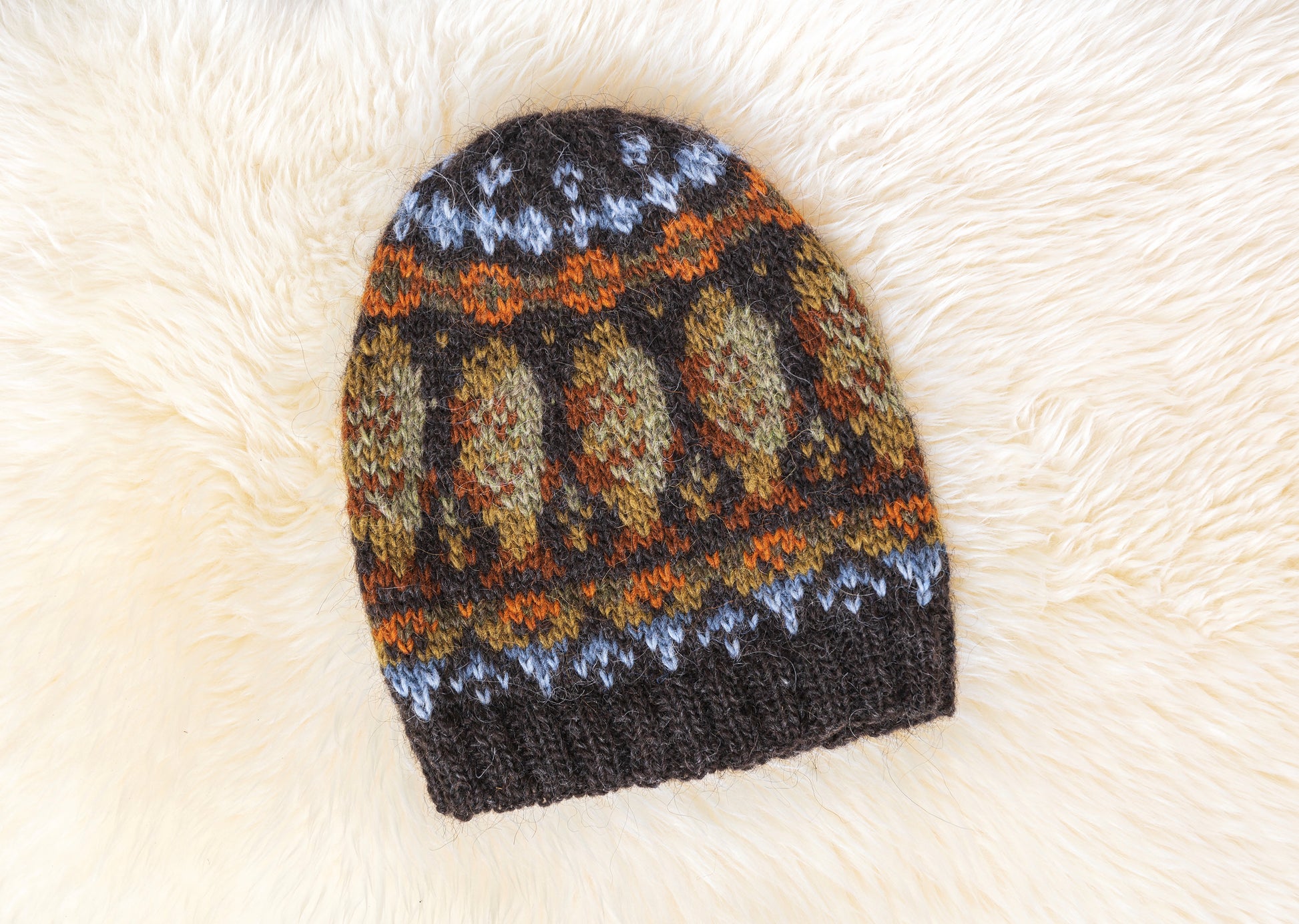 Lofoten cod fish beanie hat displayed on a white fur background