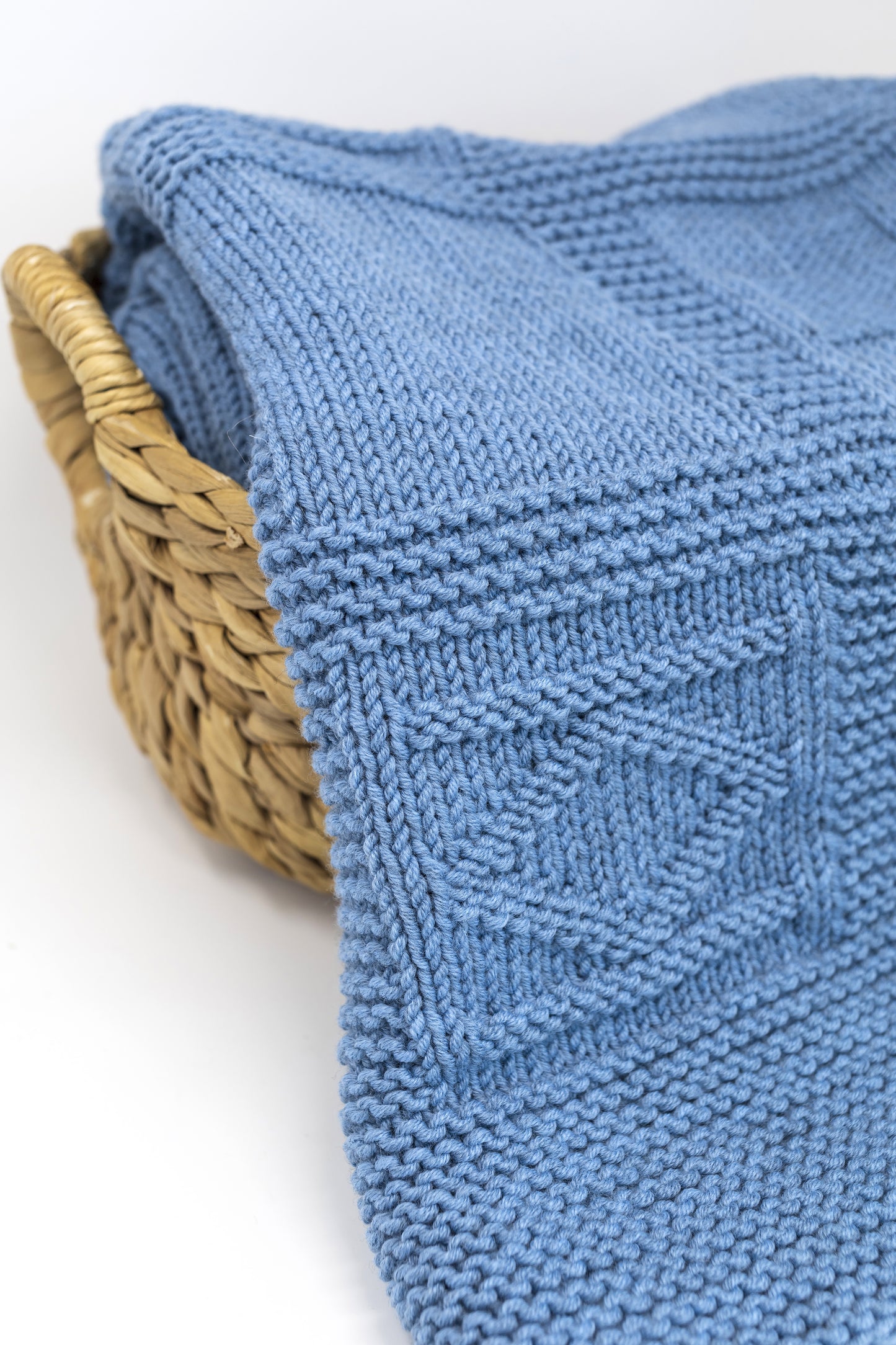 details of blue merino wool hand-knitted baby blanket in geometric knitting pattern