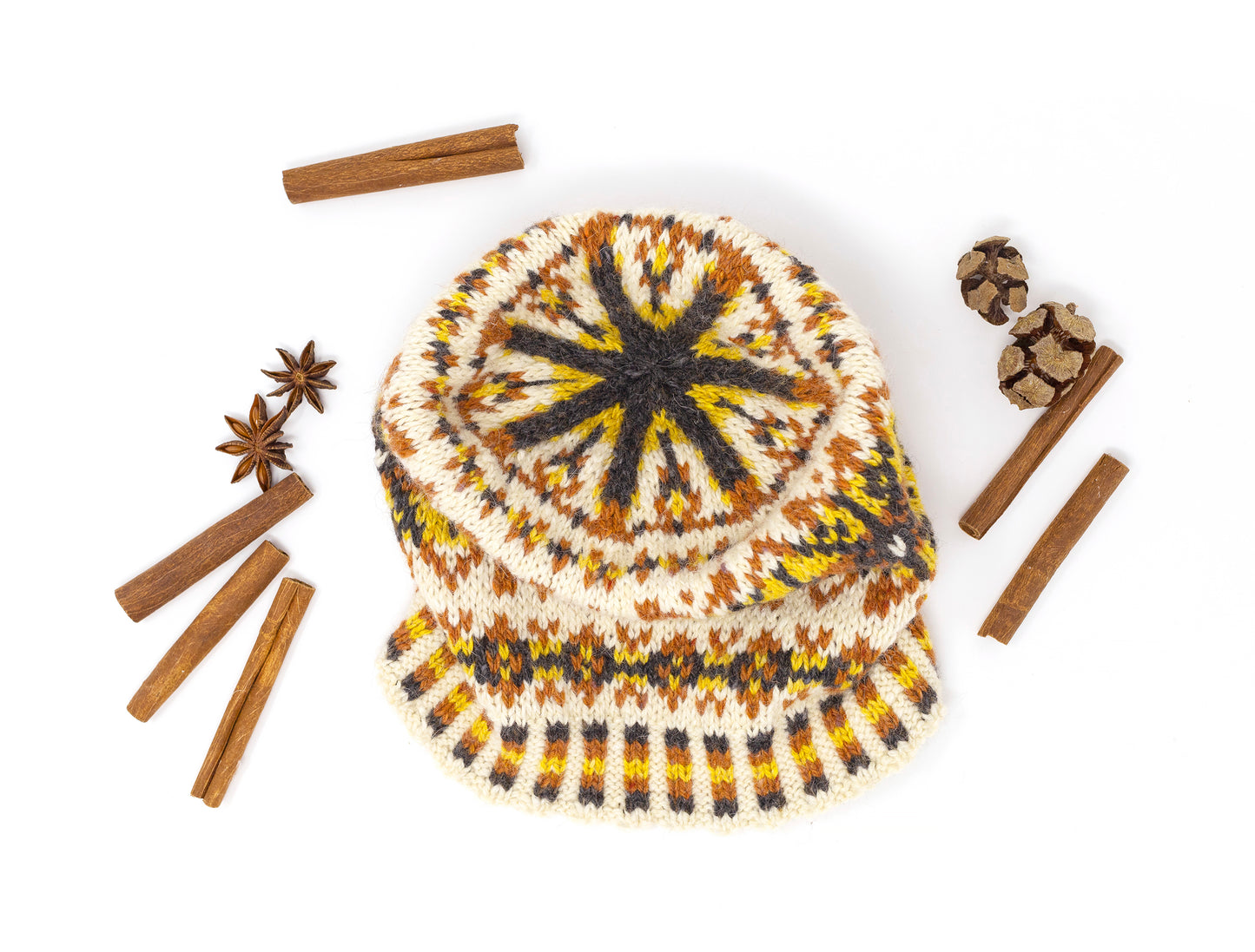 yellow, orange, black and white wool hand-knitted Fair Isle beanie hat, top view