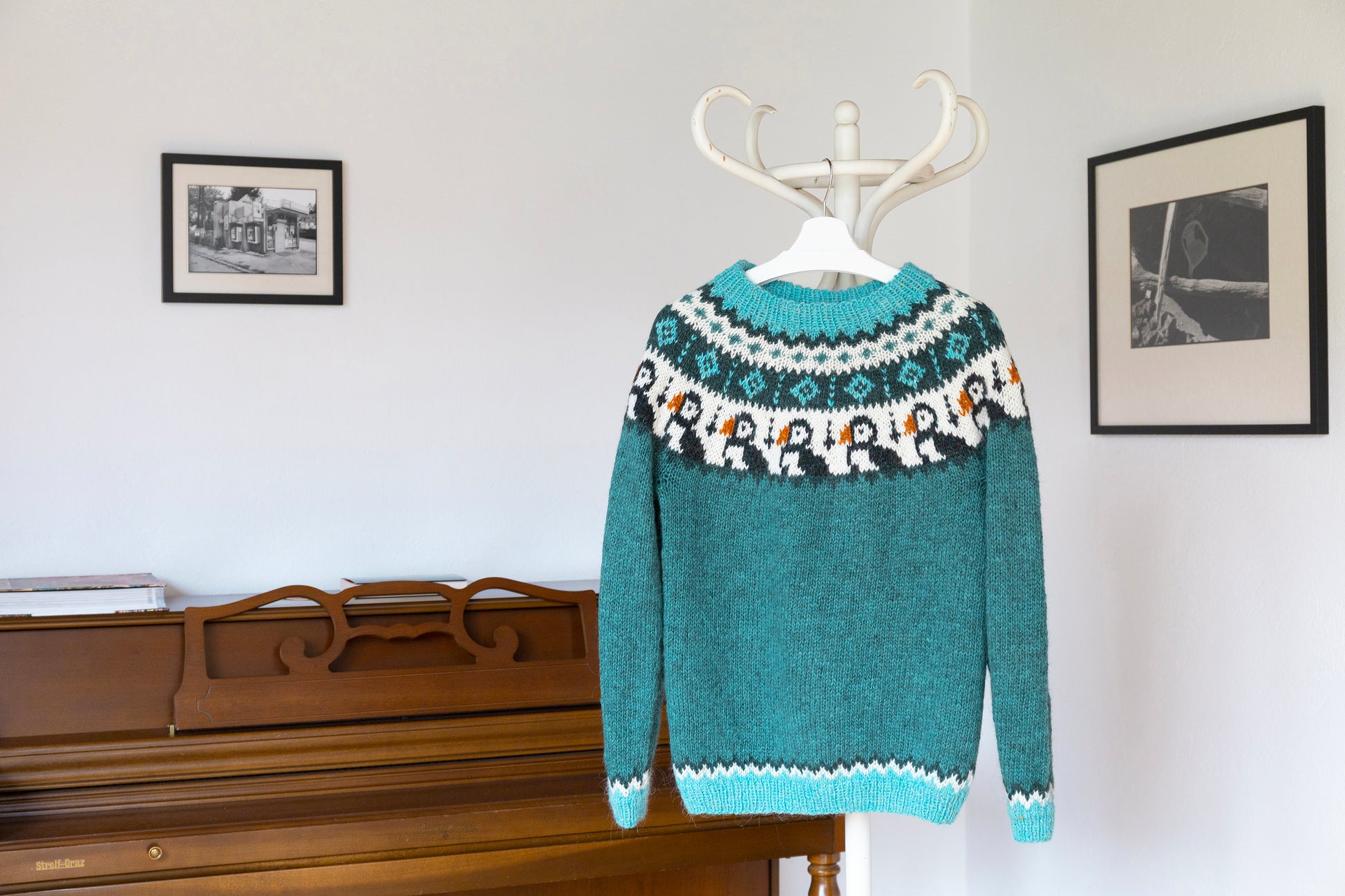 Turquoise and white knitted Icelandic lopapeysa sweater in Puffins knitting pattern in interior
