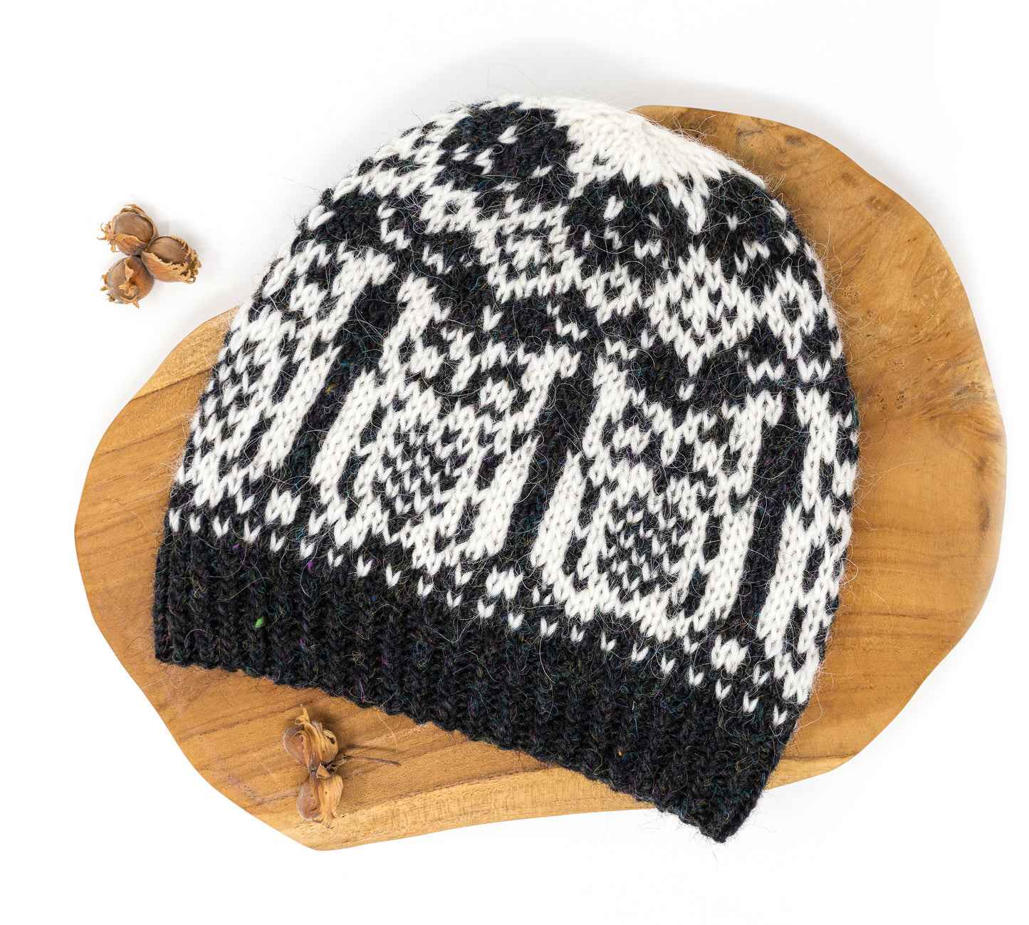 Black and white patterned knitted hat on a wooden surface