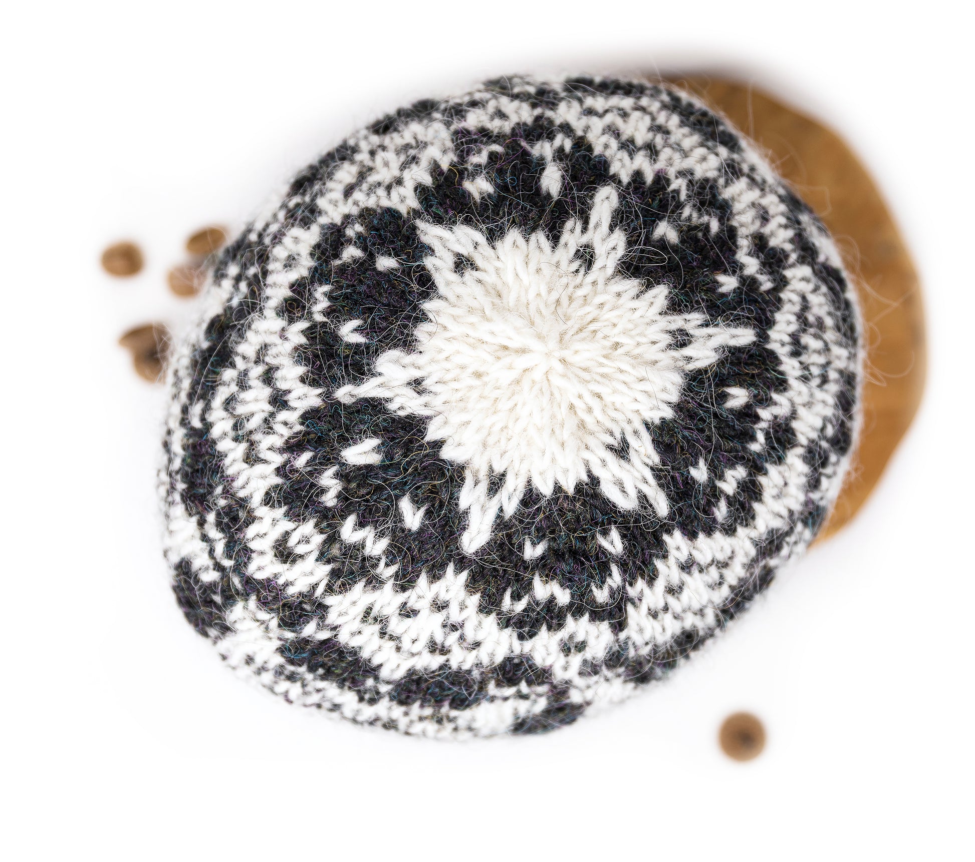 A top of Black and white knitted hat on a light background