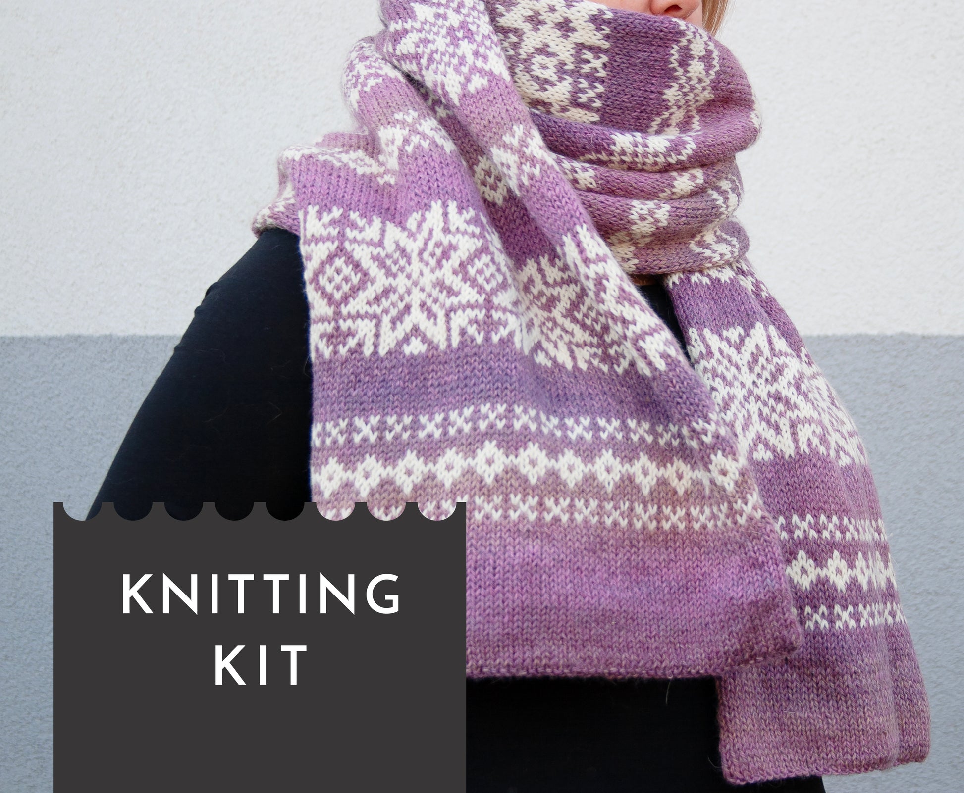 long hand-knitted Fair Isle scarf made from gradient purple and white wool yarn