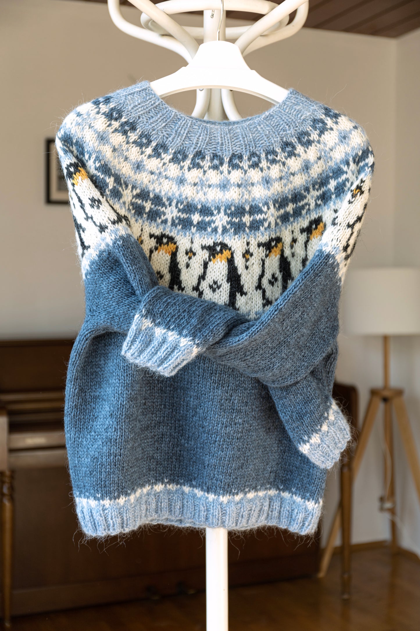 Front view of Penguin icelandic lopapeysa sweater displayed in a room