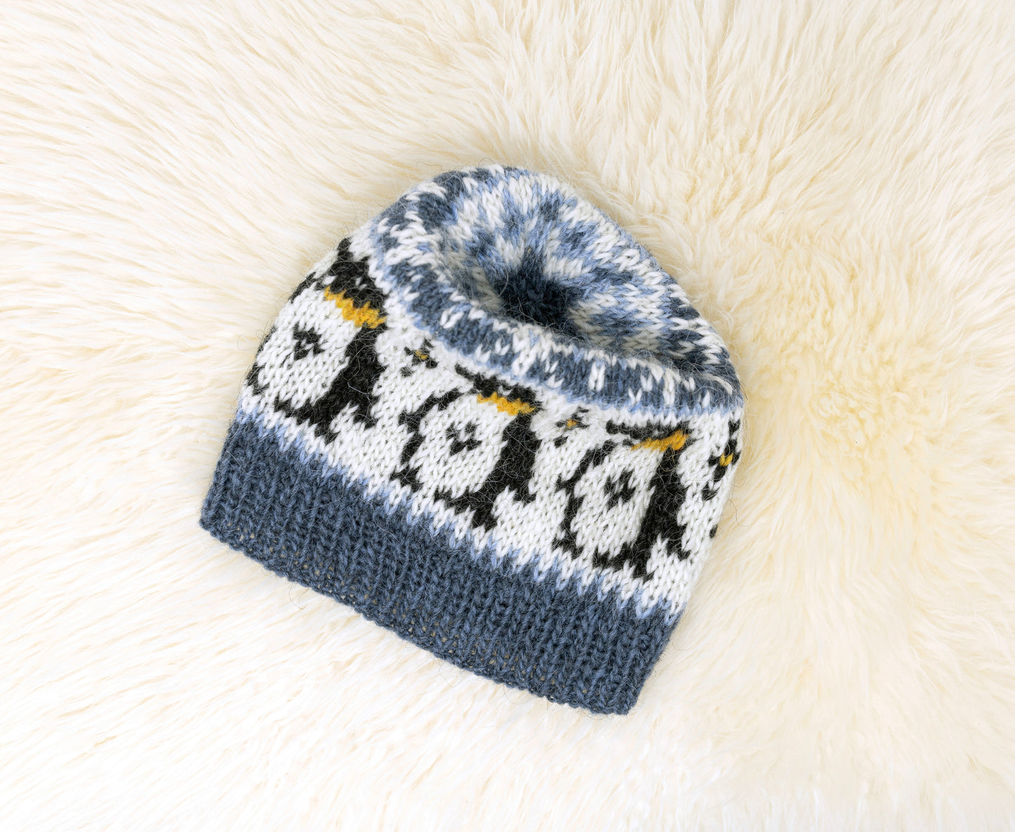 Details of a hand-knitted wool hat features penguins pattern