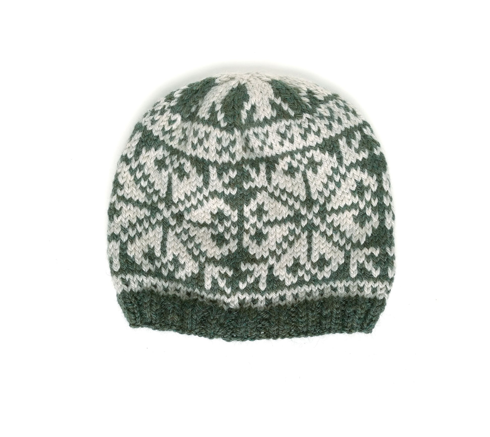 A knit beanie hat featuring a dark green and off-white Fair Isle pattern, photographed against a plain white background.