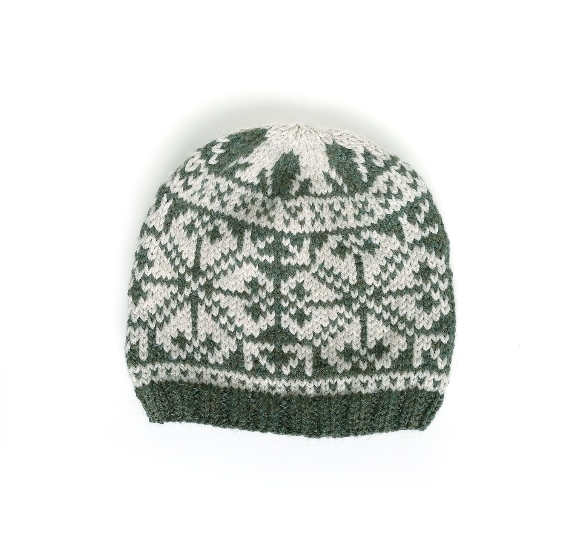 A hand-knit beanie hat featuring a classic Fair Isle snowflake pattern in dark forest green and off-white, with a solid ribbed knit brim.